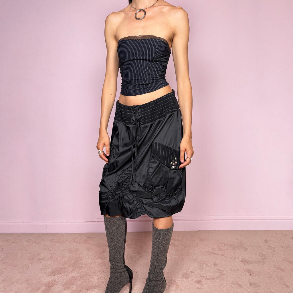 Vintage 2000s black midi skirt with a dark avant-garde parachute-style silhouette, mixed pinstripe panels, ruched construction, oversized utility pockets, tie-front details, elastic waist, and bubble hem. Rare experimental archive piece with dystopian techwear aesthetic by Elisa Cavaletti by Daniela Dallavalle. Can be worn high waisted for L or lower rise for M. Made in Italy from a polyamide polyurethane blend. Great vintage condition.