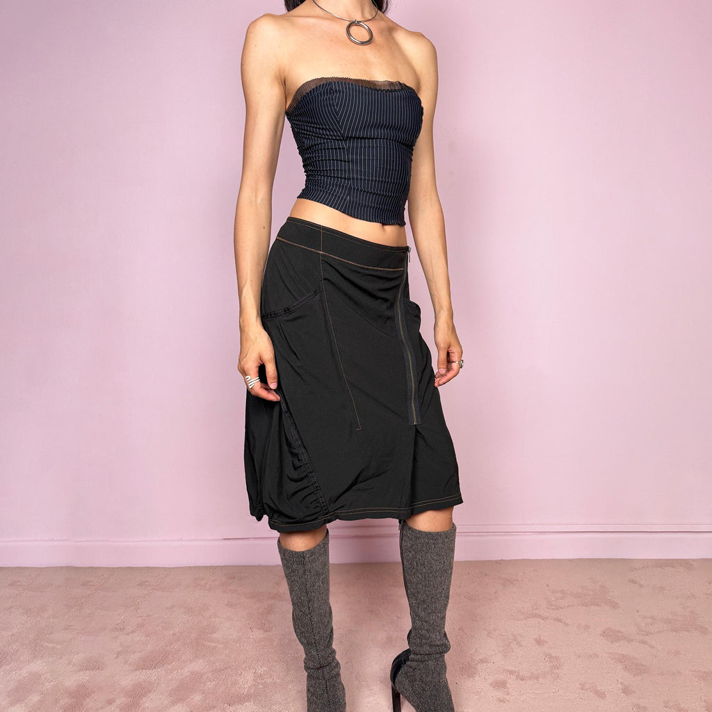 Vintage 2000s lightweight black midi skirt with a dark avant-garde dystopian techwear look. Features pockets, an asymmetric front zip closure, ruched details, contrast topstitching, and a bubble hem effect. No stretch. Can be worn mid rise for size L or lower rise for size M. Great vintage condition.