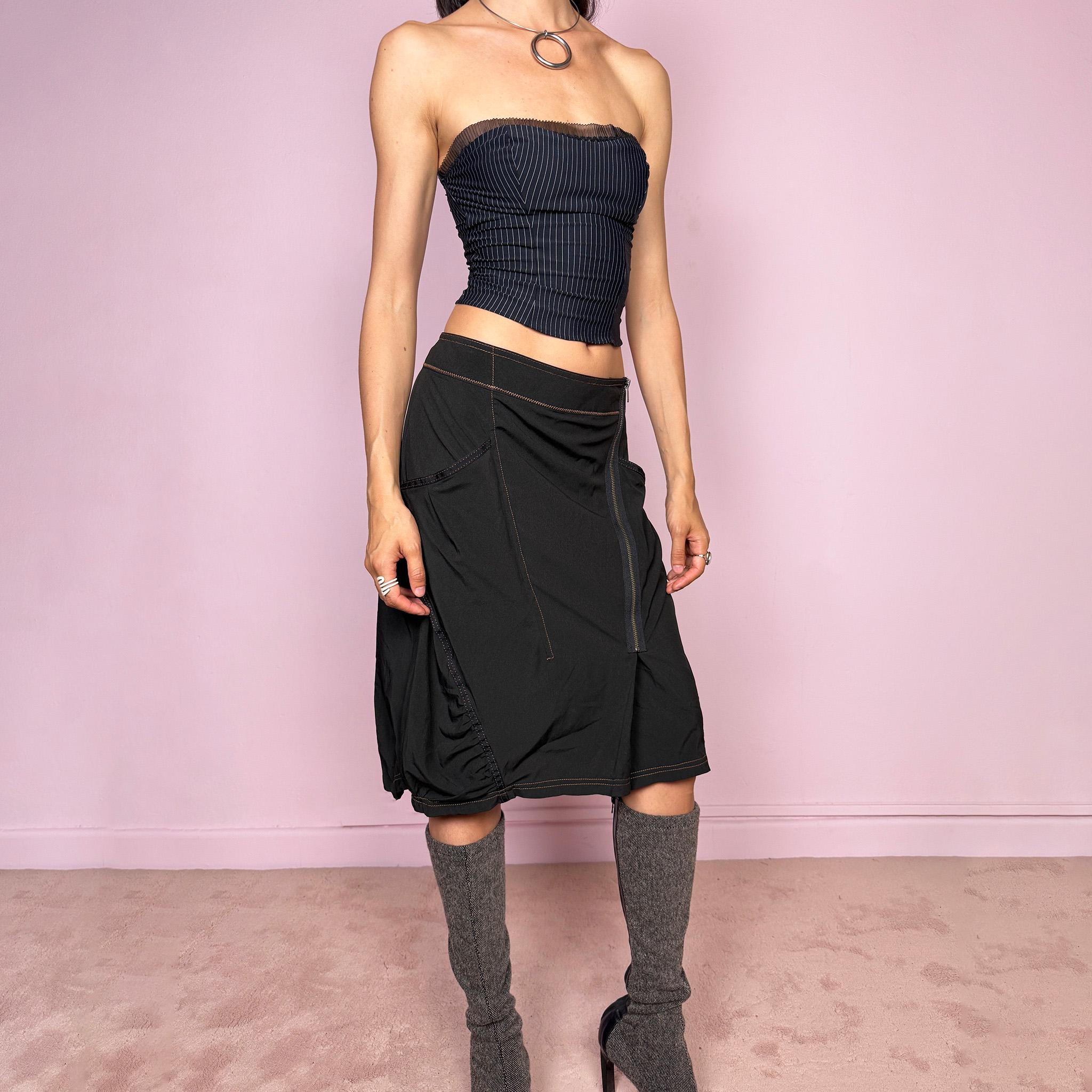Vintage 2000s lightweight black midi skirt with a dark avant-garde dystopian techwear look. Features pockets, an asymmetric front zip closure, ruched details, contrast topstitching, and a bubble hem effect. No stretch. Can be worn mid rise for size L or lower rise for size M. Great vintage condition.