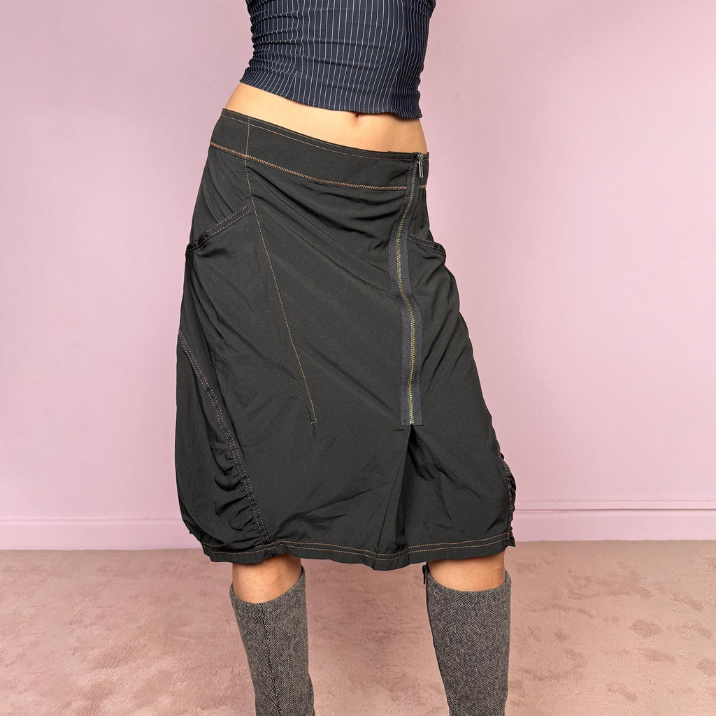 Vintage 2000s lightweight black midi skirt with a dark avant-garde dystopian techwear look. Features pockets, an asymmetric front zip closure, ruched details, contrast topstitching, and a bubble hem effect. No stretch. Can be worn mid rise for size L or lower rise for size M. Great vintage condition.