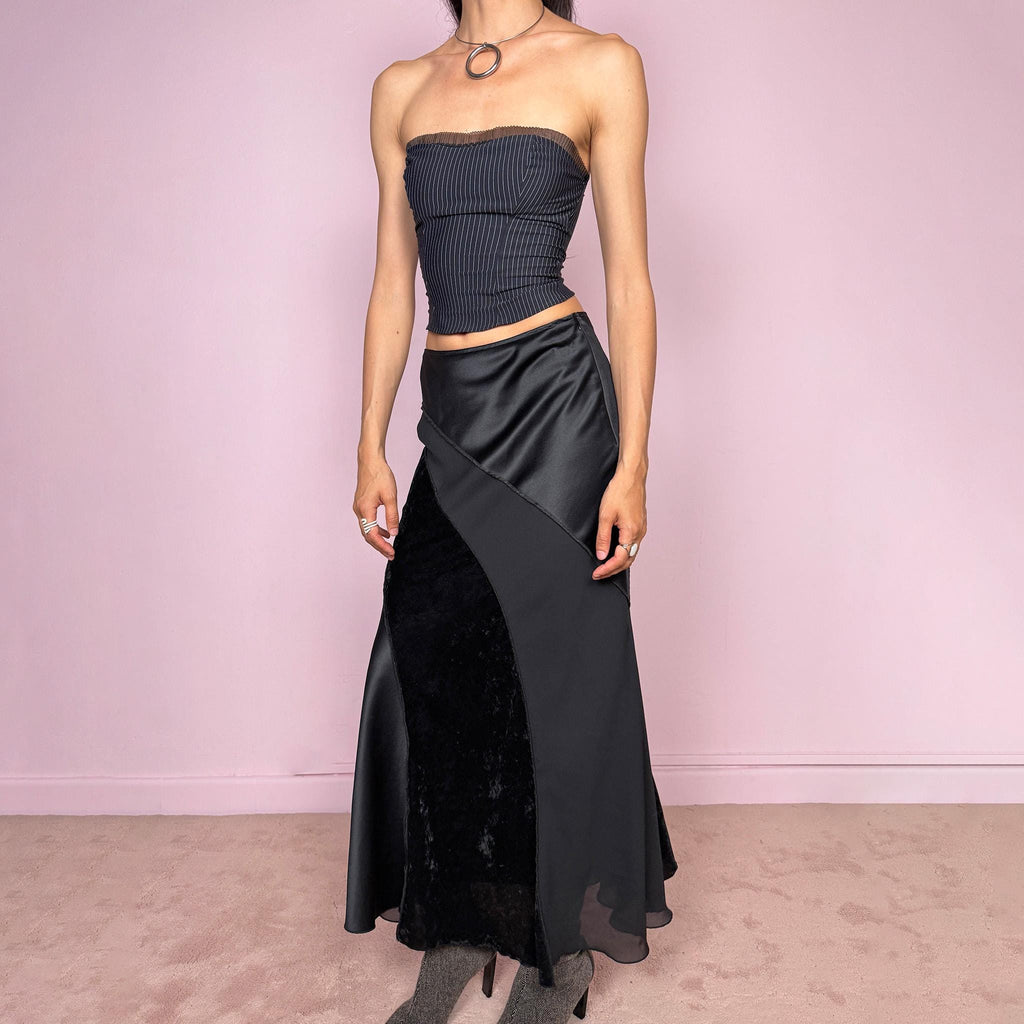 Vintage 2000s black midi skirt with a formal avant-garde minimal look, mixed velvet, satin, and sheer flare panels, asymmetric diagonal construction, side zip closure, and structured no-stretch fit. Elegant statement piece for evening, night, or event styling. Can be worn high waisted for S or lower rise for XS/XXS. Made from polyester. Excellent vintage condition.