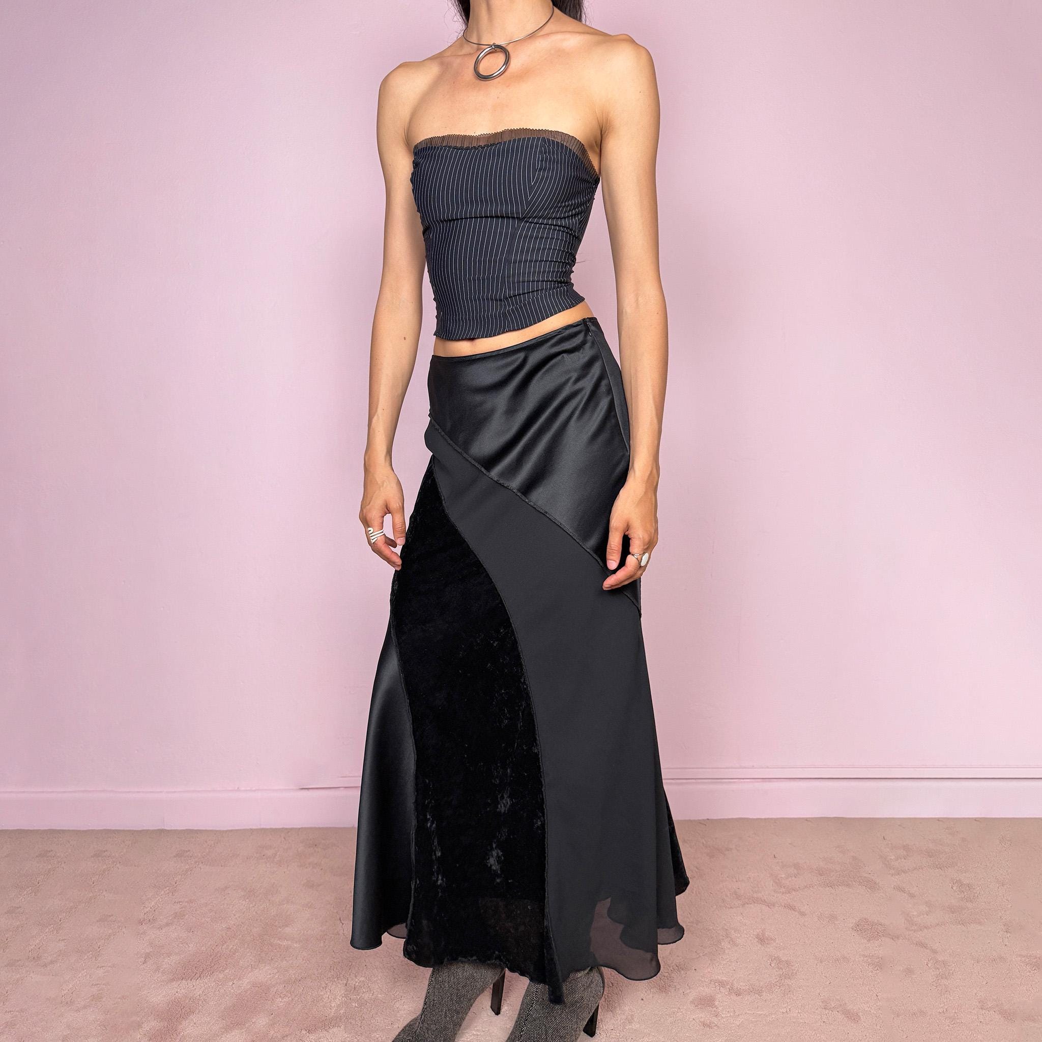 Vintage 2000s black midi skirt with a formal avant-garde minimal look, mixed velvet, satin, and sheer flare panels, asymmetric diagonal construction, side zip closure, and structured no-stretch fit. Elegant statement piece for evening, night, or event styling. Can be worn high waisted for S or lower rise for XS/XXS. Made from polyester. Excellent vintage condition.