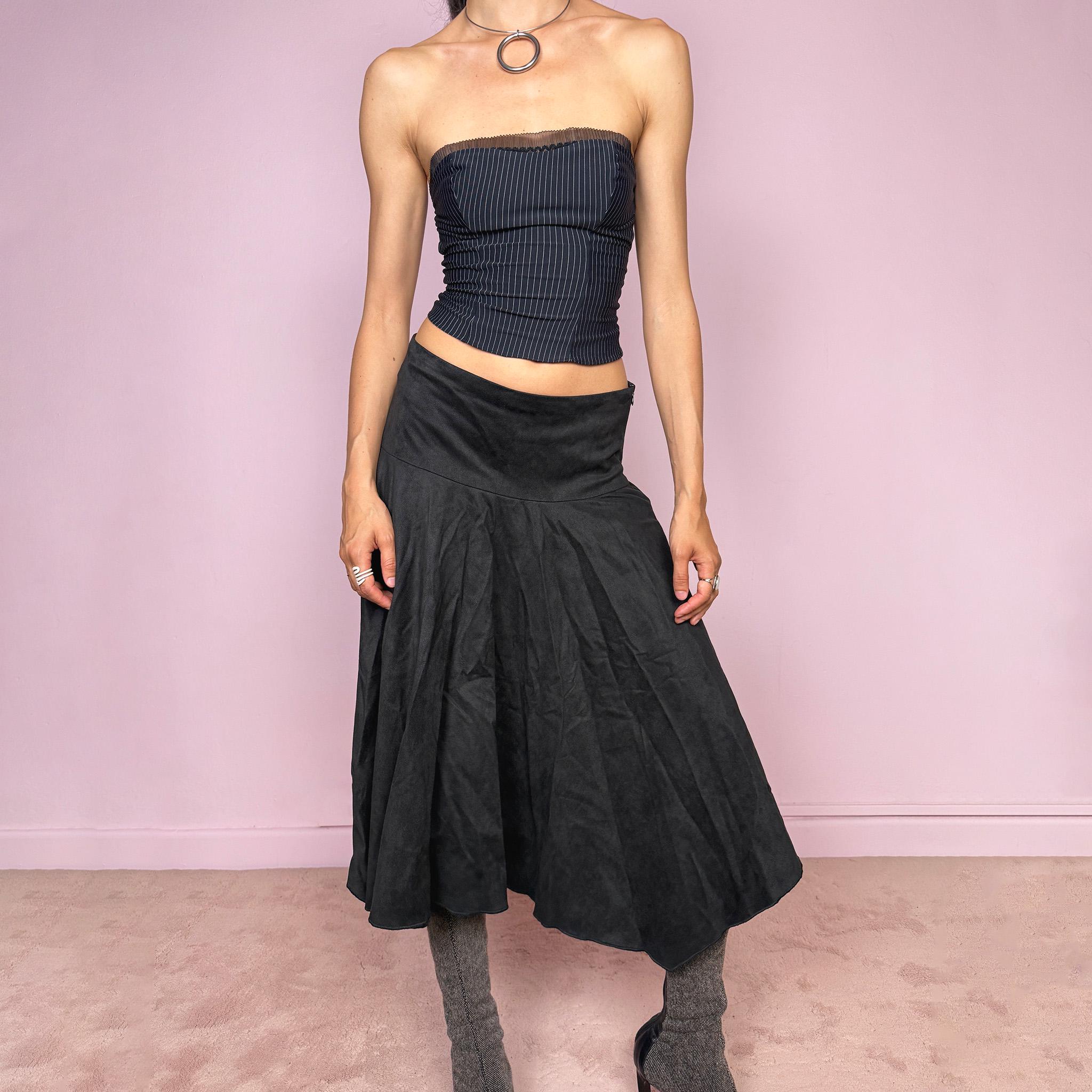 Vintage 2000s black faux suede midi skirt with a dark avant-garde minimal look. Features a softly flared silhouette, asymmetric hem, side zip closure, and structured no-stretch fit. Can be worn mid rise for size S or lower rise for XS. Made from polyester and acetate. Excellent vintage condition.