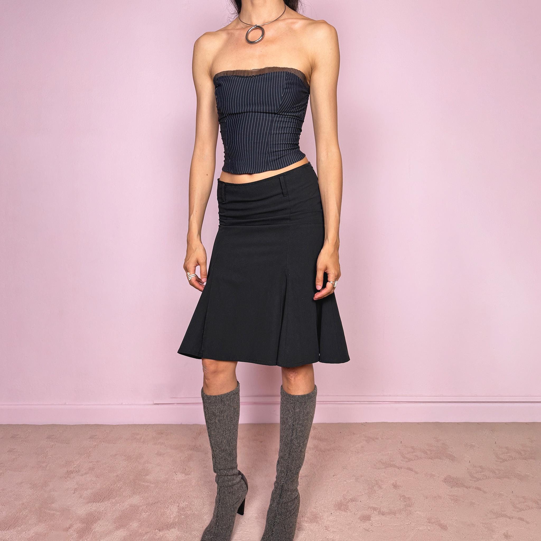 Vintage 2000s classic black midi skirt with a formal romantic feel. Features a sleek trumpet godet silhouette, side zip closure, belt loops, and a structured no-stretch fit. Perfect for elevated everyday or minimal styling. Can be worn mid rise for size XS or lower rise for XXS. Made in France from polyester, viscose, and elastane. Great vintage condition.