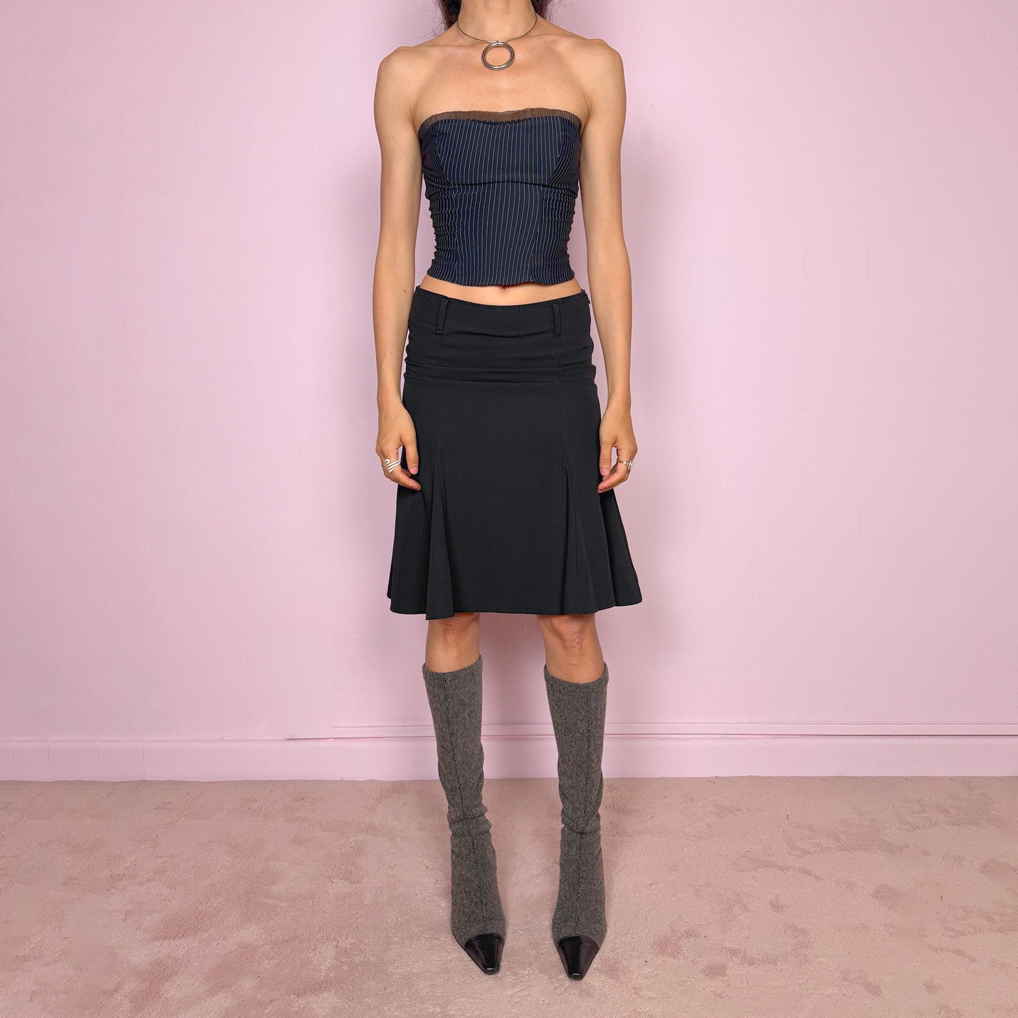 Vintage 2000s classic black midi skirt with a formal romantic feel. Features a sleek trumpet godet silhouette, side zip closure, belt loops, and a structured no-stretch fit. Perfect for elevated everyday or minimal styling. Can be worn mid rise for size XS or lower rise for XXS. Made in France from polyester, viscose, and elastane. Great vintage condition.