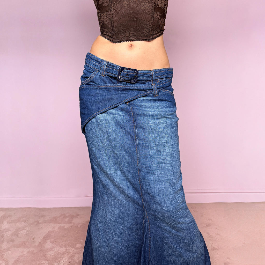 Vintage 2000s Jean’s Paul Gaultier blue denim mermaid maxi skirt made in Italy from a 68% cotton and 32% linen blend. Features a low rise, asymmetric belt detail, front zip closure, belt loops, and a dramatic flared mermaid godet-style hem. Designed with no stretch for a sculpted silhouette. A rare Y2K designer piece. Excellent vintage condition.