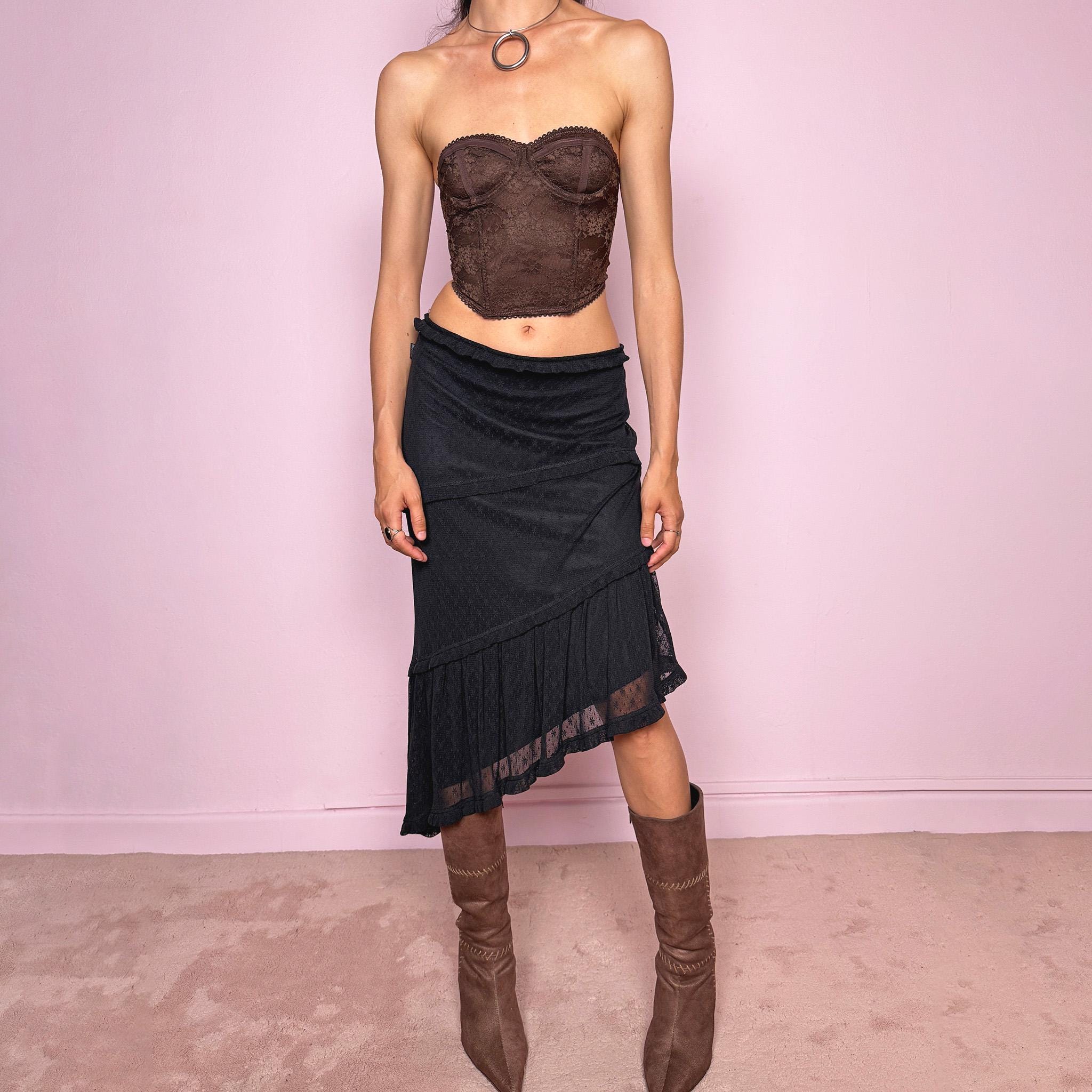 Vintage 2000s Moschino Jeans black lace asymmetric midi skirt made in Italy from a stretchy polyamide fabric. Features a low-rise, soft stretch waistband without elastic, delicate ruffle trim, layered asymmetric panels, and a sheer lace pleated hem. A dark romantic Y2K designer piece, perfect for elevated evening looks. Excellent vintage condition.