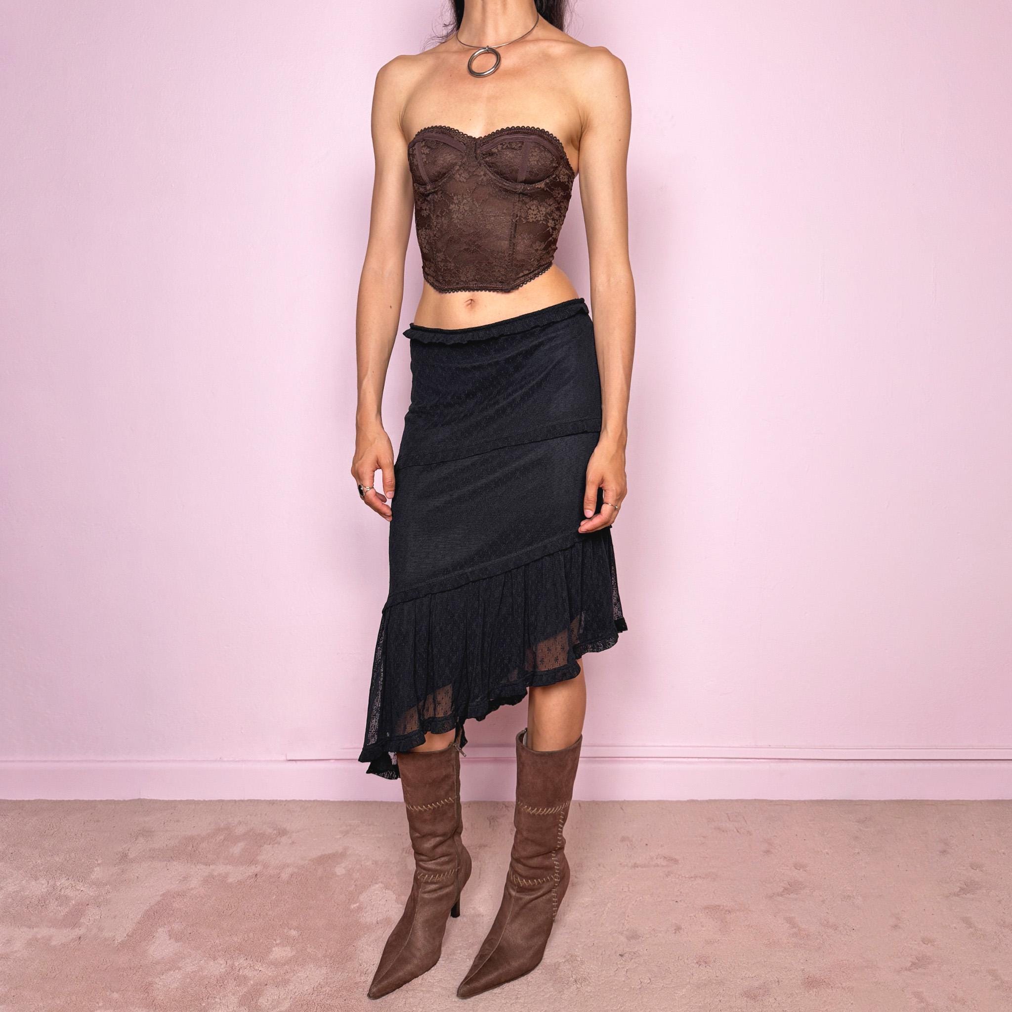 Vintage 2000s Moschino Jeans black lace asymmetric midi skirt made in Italy from a stretchy polyamide fabric. Features a low-rise, soft stretch waistband without elastic, delicate ruffle trim, layered asymmetric panels, and a sheer lace pleated hem. A dark romantic Y2K designer piece, perfect for elevated evening looks. Excellent vintage condition.
