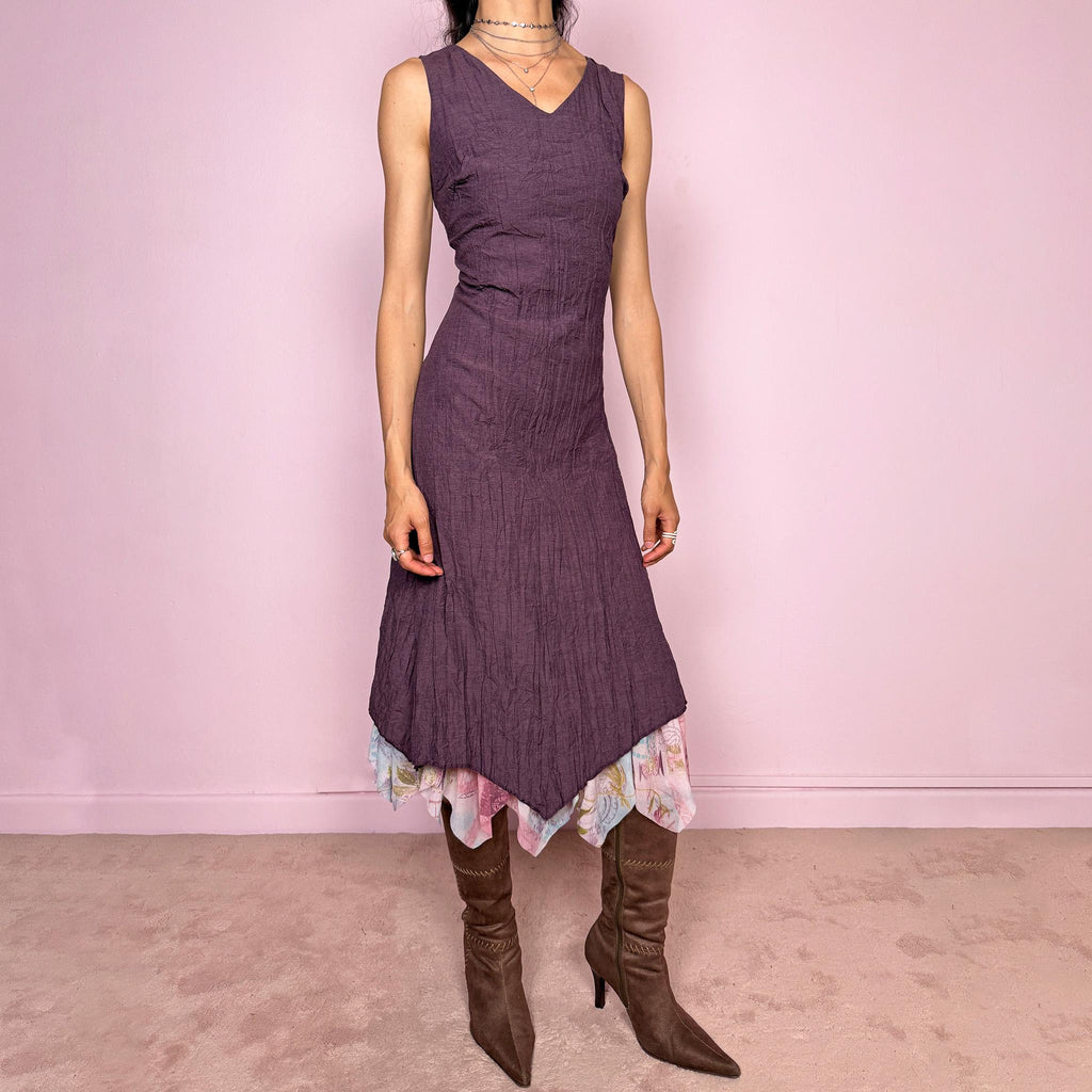 Vintage 2000s purple sleeveless midi dress with a minimal avant-garde look, no stretch, V-neckline, crinkle texture, flowy fit, side zip closure, and an asymmetric hem with graphic print mesh ruffle detail. Made by a French brand from a polyester viscose blend. Great vintage condition.