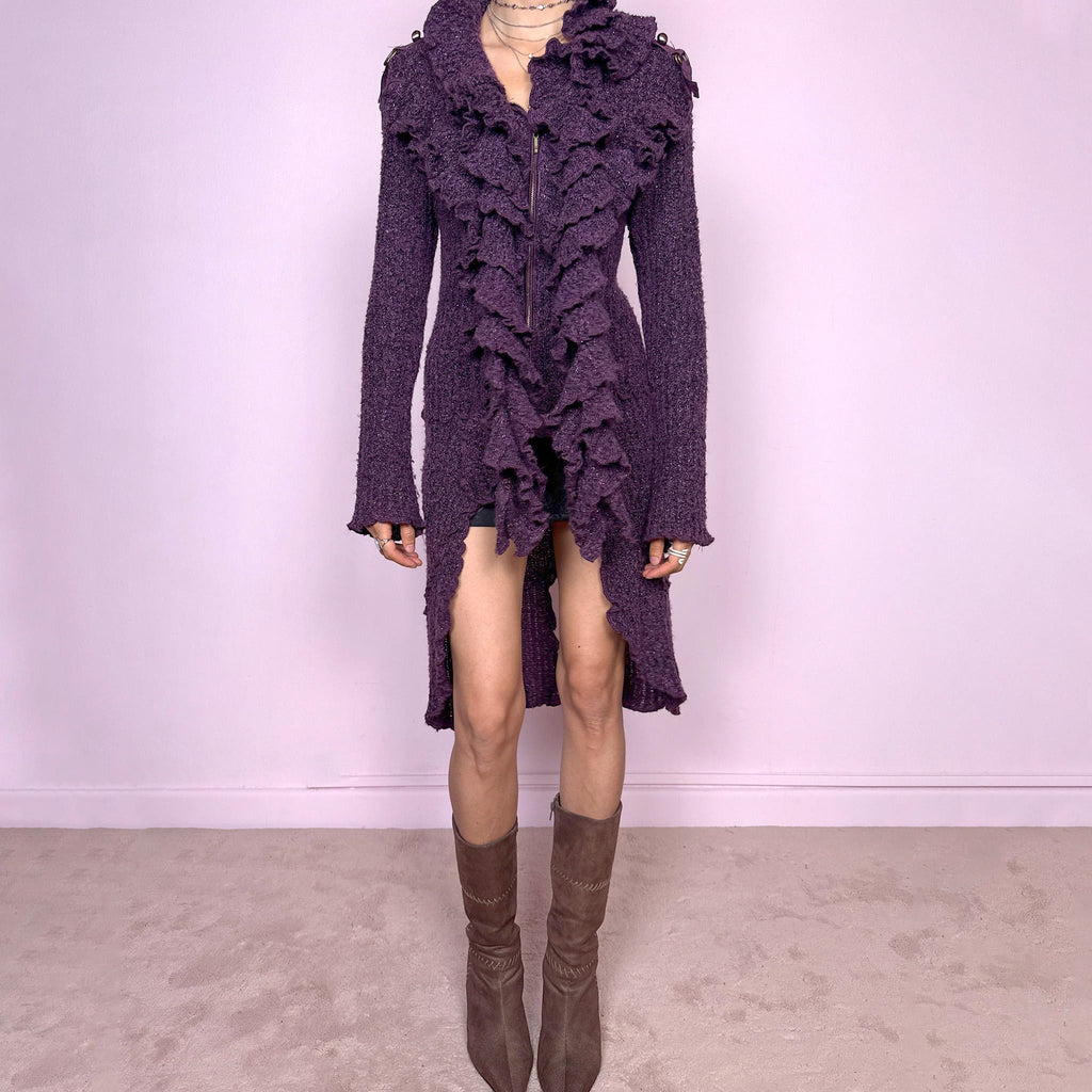 Vintage 2000s purple and black longline crazy cardigan with metallic thread, a zip-front closure, long bell sleeves, sculptural ruffle neckline, 3D cascading front ruffles, and an asymmetric high-low hem. Dramatic, extravagant, and bold for winter. Made by a French brand from an acrylic polyester blend. Great vintage condition.