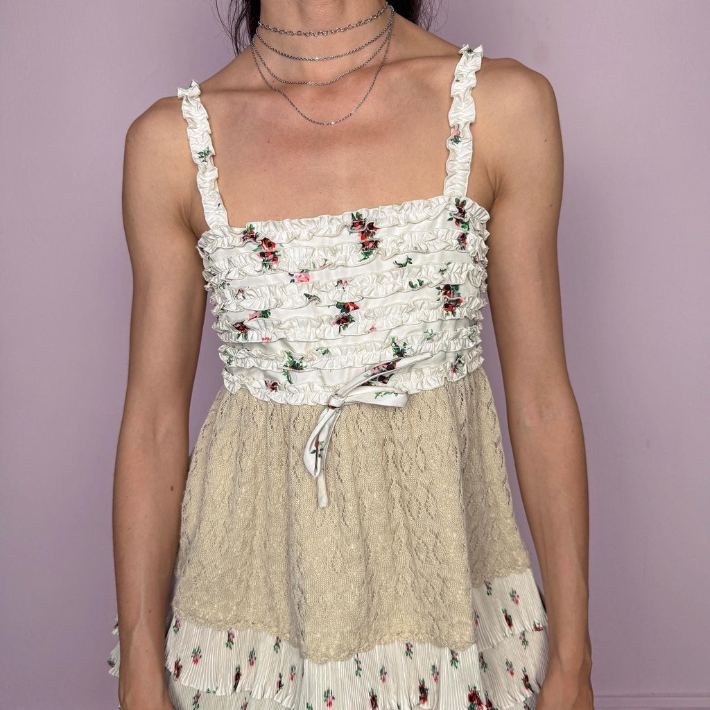 Vintage 2000s romantic ruffled cami top in a delicate cream floral print with layered pleated details, beige knit paneling, and a feminine fitted babydoll-style silhouette. Featuring tiered ruffle trims, a 70% silk and 30% wool knit blend overlay through the waist, and a back zip closure. No stretch. Rare Y2K designer piece with a romantic bohemian/fairy-like aesthetic. Made by the French brand Manoush, with lining and other fabric made from a cotton-polyester blend. Great vintage condition.