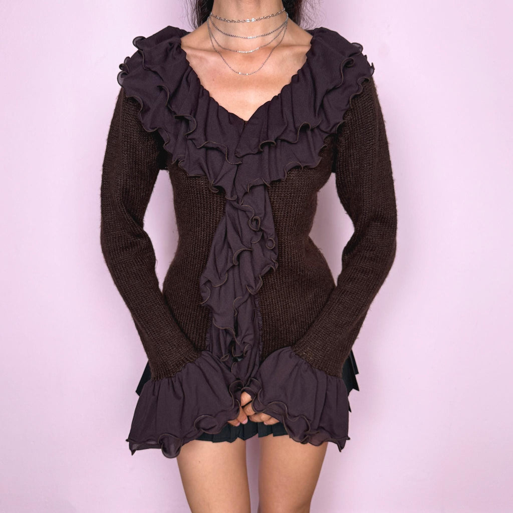 Vintage 2000s dark brown cardigan made from a stretchy knit, featuring dramatic layered mesh ruffles, delicate front buttons, and flared ruffle cuffs. A feminine dark fairy Y2K piece with a romantic statement silhouette. Made from 35% wool, 10% cashmere, and 55% acrylic. Great vintage condition.