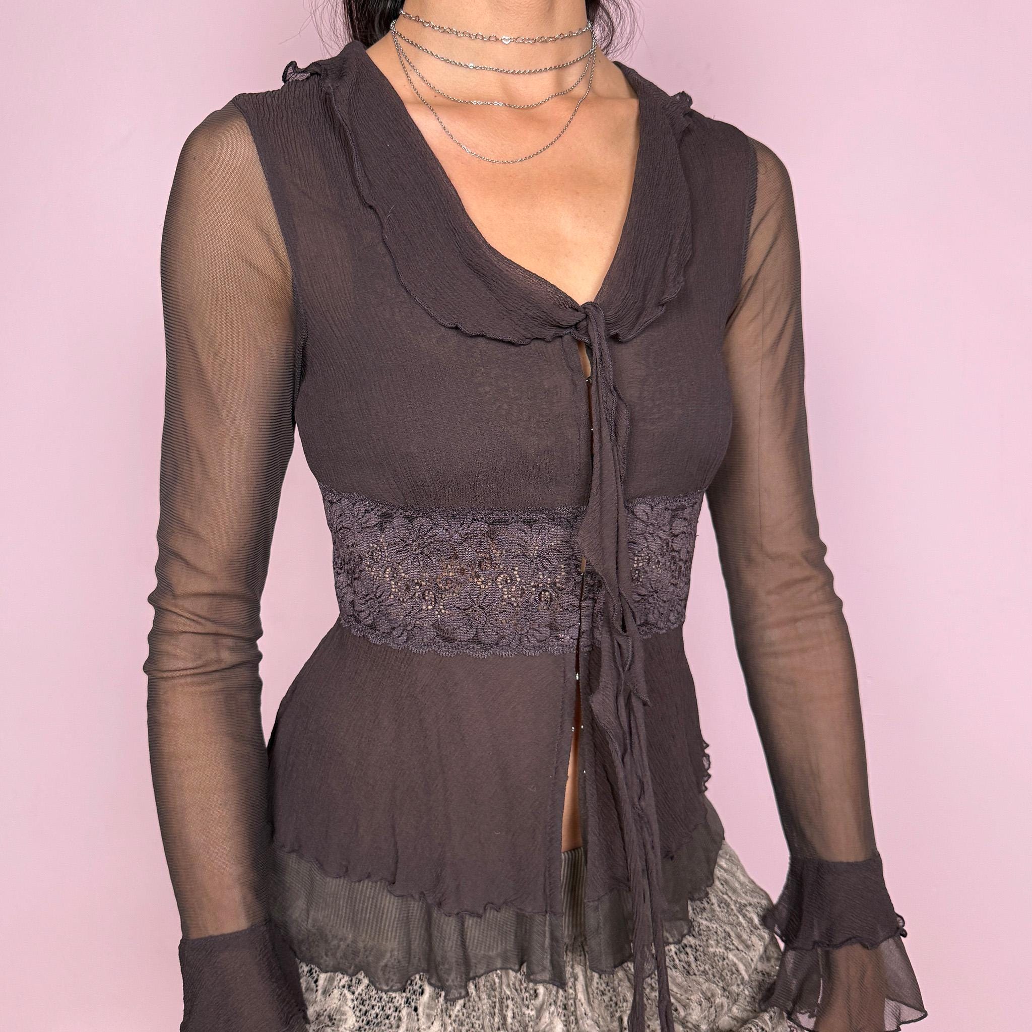 Vintage 2000s delicate brown semi-sheer top featuring long transparent mesh sleeves with ruffle cuffs, lace panels, a stretchy fit, a tiny front hook closure, and a tie-front detail at the neckline. A feminine dark romantic Y2K statement blouse. From a French brand. Excellent vintage condition.