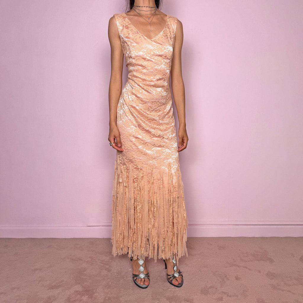 Vintage 2000s pastel peach lace maxi dress. Features a romantic V-neckline, fitted sleeveless silhouette, side zip closure, and a dramatic fringed lace hem. A refined occasion dress in a soft peach, salmon, and blush pink tone, perfect for romantic evening styling, spring-summer events, weddings, or elevated vintage looks. Made in Spain by a Spanish designer, with a nylon-cotton blend outer layer and polyester lining, with no stretch. Excellent vintage condition.