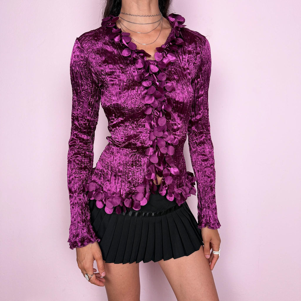 Romantic vintage 2000s purple crinkle pleated top with long flared sleeves. Features a button front and dramatic 3D floral petal trim appliqué cascading along the neckline and opening for an avant garde look. Perfect for formal, party, night, or evening wear. From a French brand. Made from 100% polyester. Excellent vintage condition.