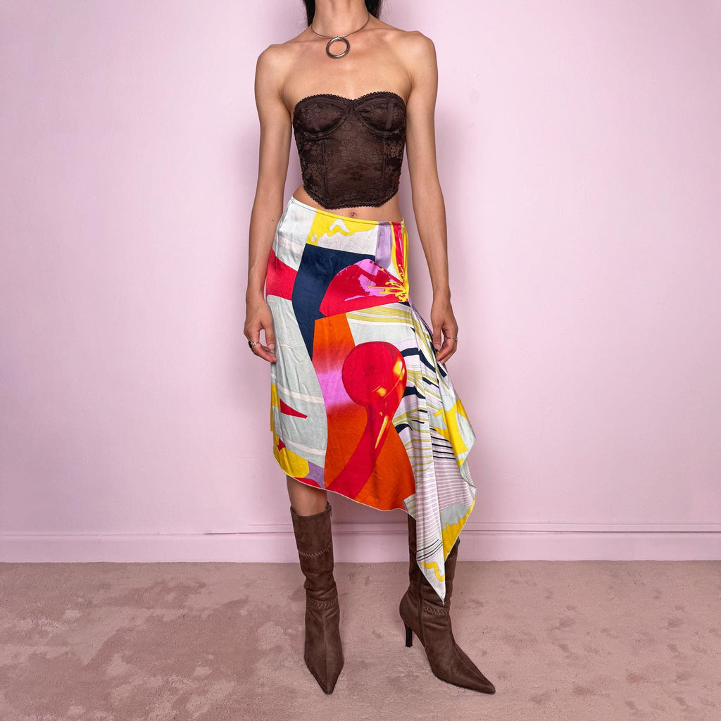 Vintage 2000s Christian Lacroix Bazar asymmetric skirt made in France from 100% silk. Features a bold multicolor abstract print, side zip closure, no stretch, and a beautiful asymmetric draped hem. A rare designer statement piece with an artistic Y2K resort feel, perfect for elevated summer looks. Can be worn high-waisted for size S or lower-rise for XS.
