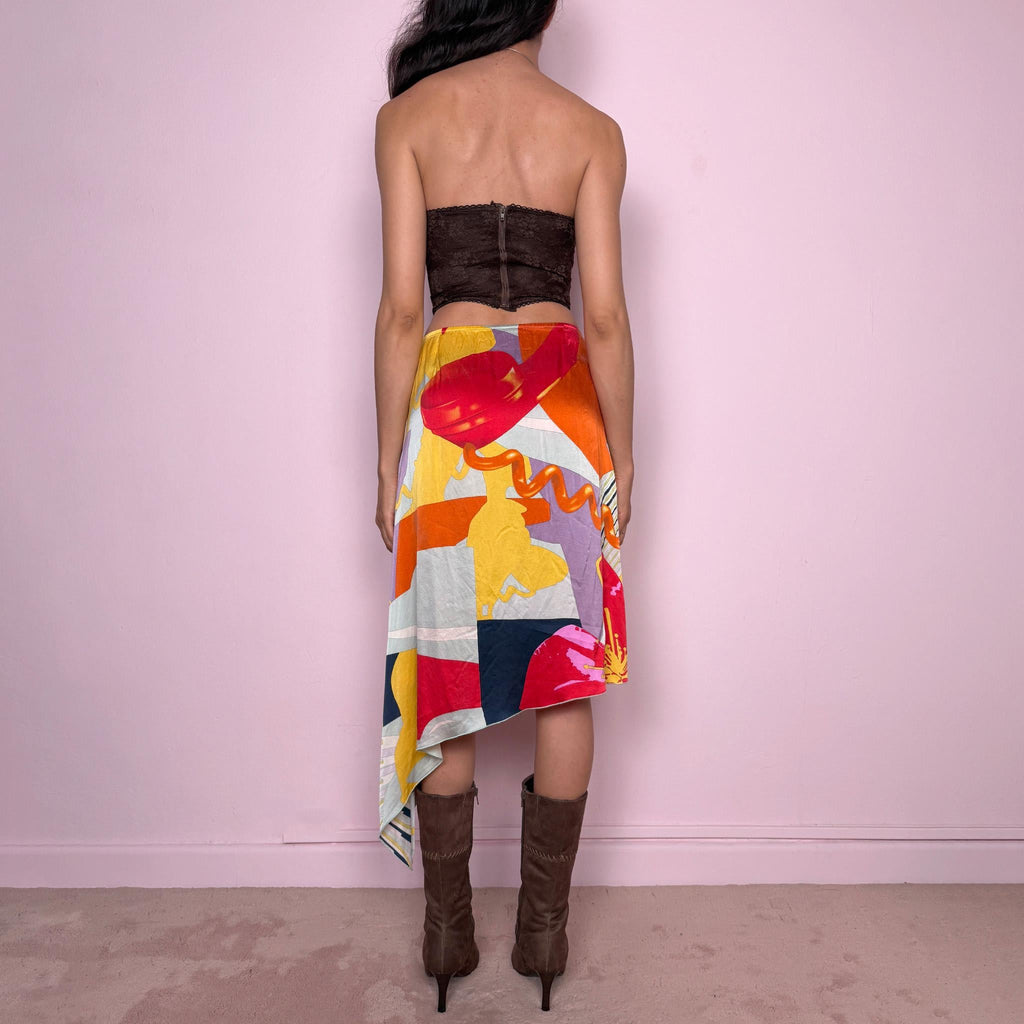 Vintage 2000s Christian Lacroix Bazar asymmetric skirt made in France from 100% silk. Features a bold multicolor abstract print, side zip closure, no stretch, and a beautiful asymmetric draped hem. A rare designer statement piece with an artistic Y2K resort feel, perfect for elevated summer looks. Can be worn high-waisted for size S or lower-rise for XS.