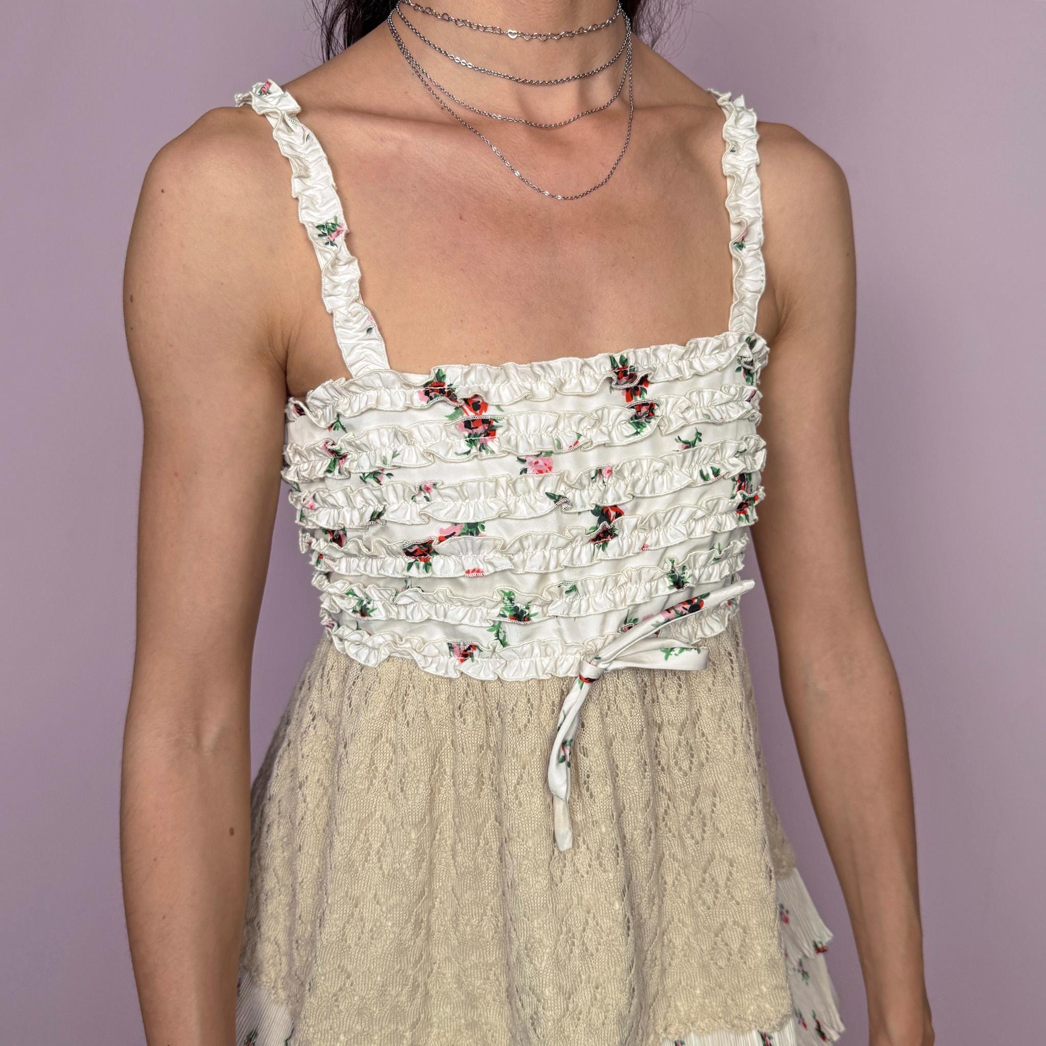 Vintage 2000s romantic ruffled cami top in a delicate cream floral print with layered pleated details, beige knit paneling, and a feminine fitted babydoll-style silhouette. Featuring tiered ruffle trims, a 70% silk and 30% wool knit blend overlay through the waist, and a back zip closure. No stretch. Rare Y2K designer piece with a romantic bohemian/fairy-like aesthetic. Made by the French brand Manoush, with lining and other fabric made from a cotton-polyester blend. Great vintage condition.