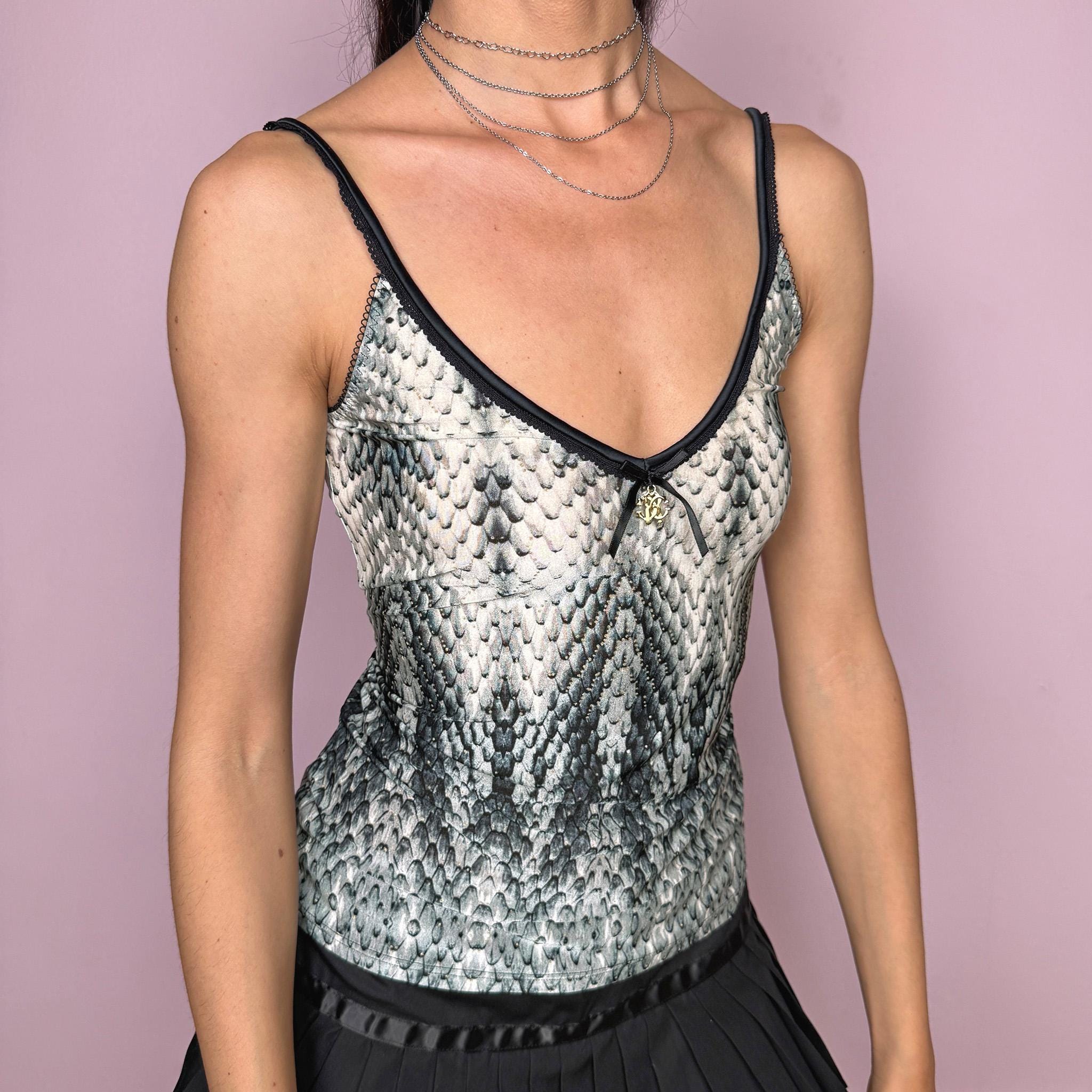Vintage 2000s Roberto Cavalli Underwear white cami top in a striking black, gray, and greenish snake/reptile print with a fitted stretchy silhouette, black trims, and a delicate front bow detail with a gold-tone Cavalli charm. Made in Italy from a 75% polyamide and 25% elastane blend, with a flattering deep V neckline and thin straps. A sensual Y2K piece for lingerie-as-outerwear looks. Excellent vintage condition.
