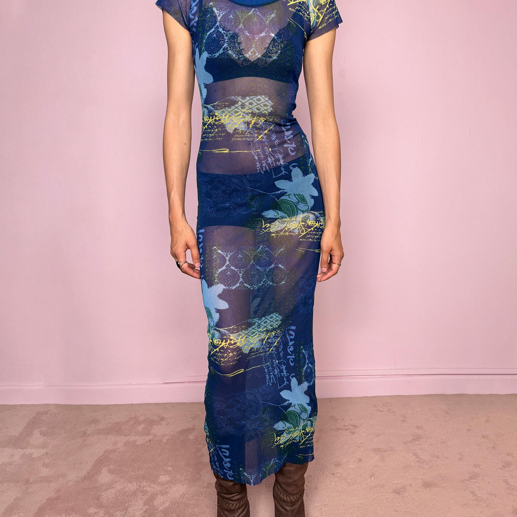 Vintage 2000s Kenzo Jeans sheer mesh maxi dress in a striking dark blue abstract patchwork print with floral and graphic details throughout. Designed in a fitted long silhouette with short sleeves, a round neckline, and lightweight semi-sheer fabric. A bold 90s/early Y2K designer piece with a futuristic avant-garde aesthetic, perfect for an editorial look.