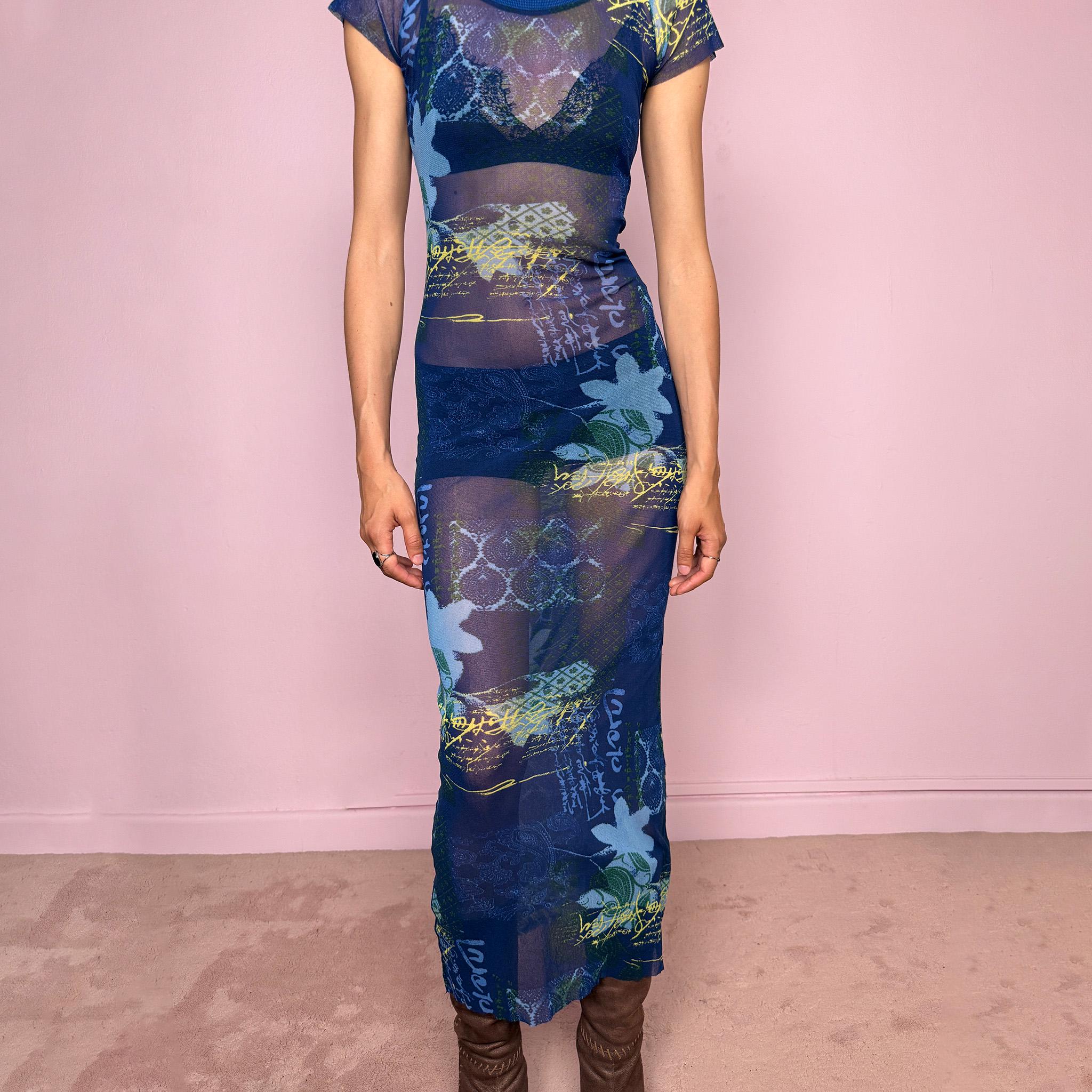 Vintage 2000s Kenzo Jeans sheer mesh maxi dress in a striking dark blue abstract patchwork print with floral and graphic details throughout. Designed in a fitted long silhouette with short sleeves, a round neckline, and lightweight semi-sheer fabric. A bold 90s/early Y2K designer piece with a futuristic avant-garde aesthetic, perfect for an editorial look.