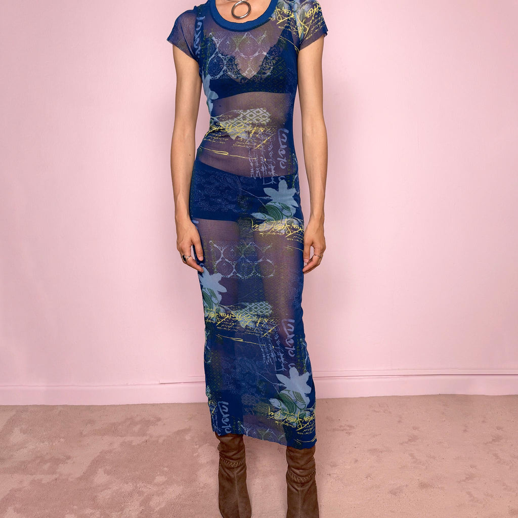 Vintage 2000s Kenzo Jeans sheer mesh maxi dress in a striking dark blue abstract patchwork print with floral and graphic details throughout. Designed in a fitted long silhouette with short sleeves, a round neckline, and lightweight semi-sheer fabric. A bold 90s/early Y2K designer piece with a futuristic avant-garde aesthetic, perfect for an editorial look.