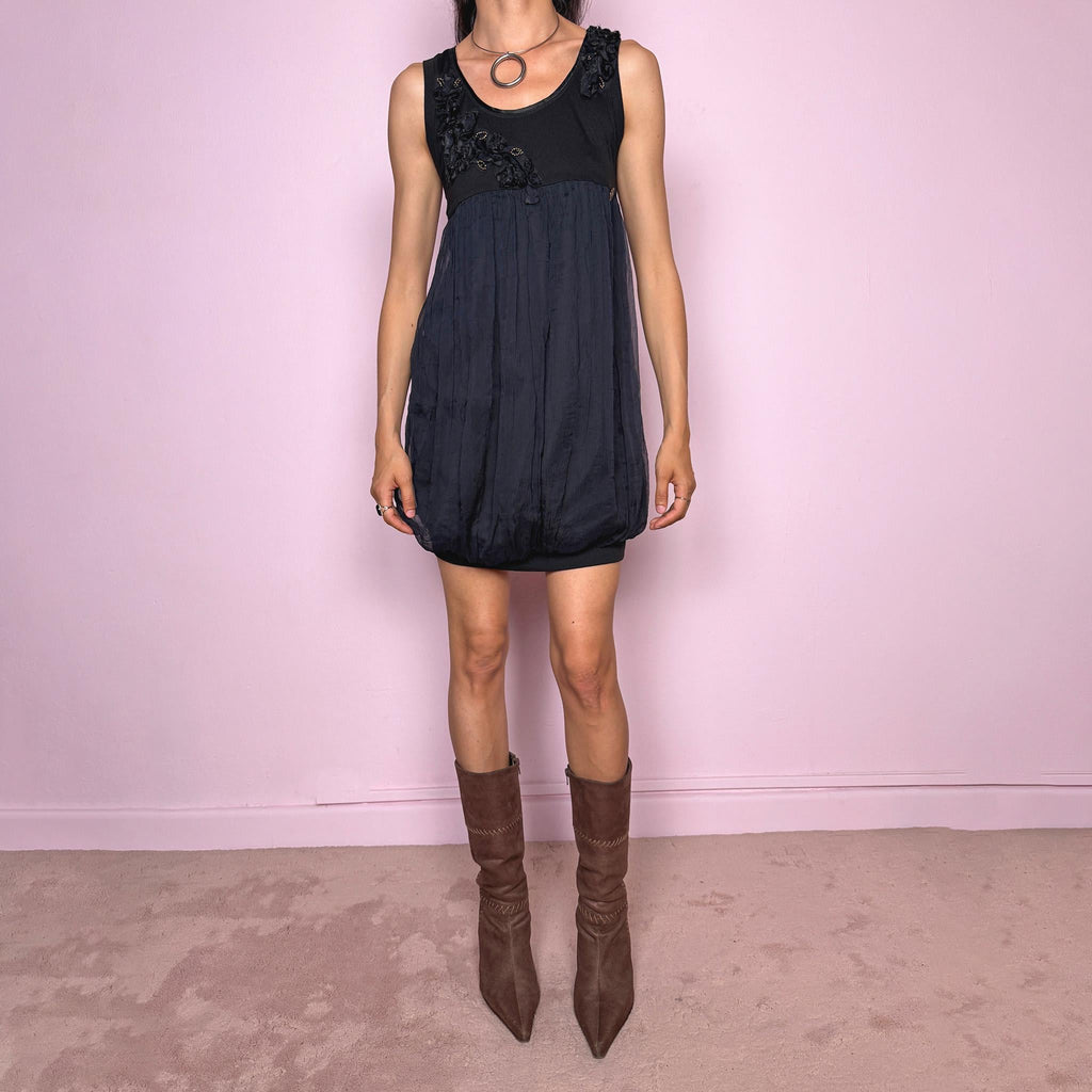 Vintage 2000s Galliano black bubble mini dress featuring a fitted stretchy cotton sleeveless bodice, floral appliqué details at the neckline, a voluminous crinkled semi-sheer viscose overlay, and a bubble hem silhouette. Beautiful late 90s / early 2000s dark romantic, slightly gothic, and very feminine aesthetic, perfect for elevated evening looks.