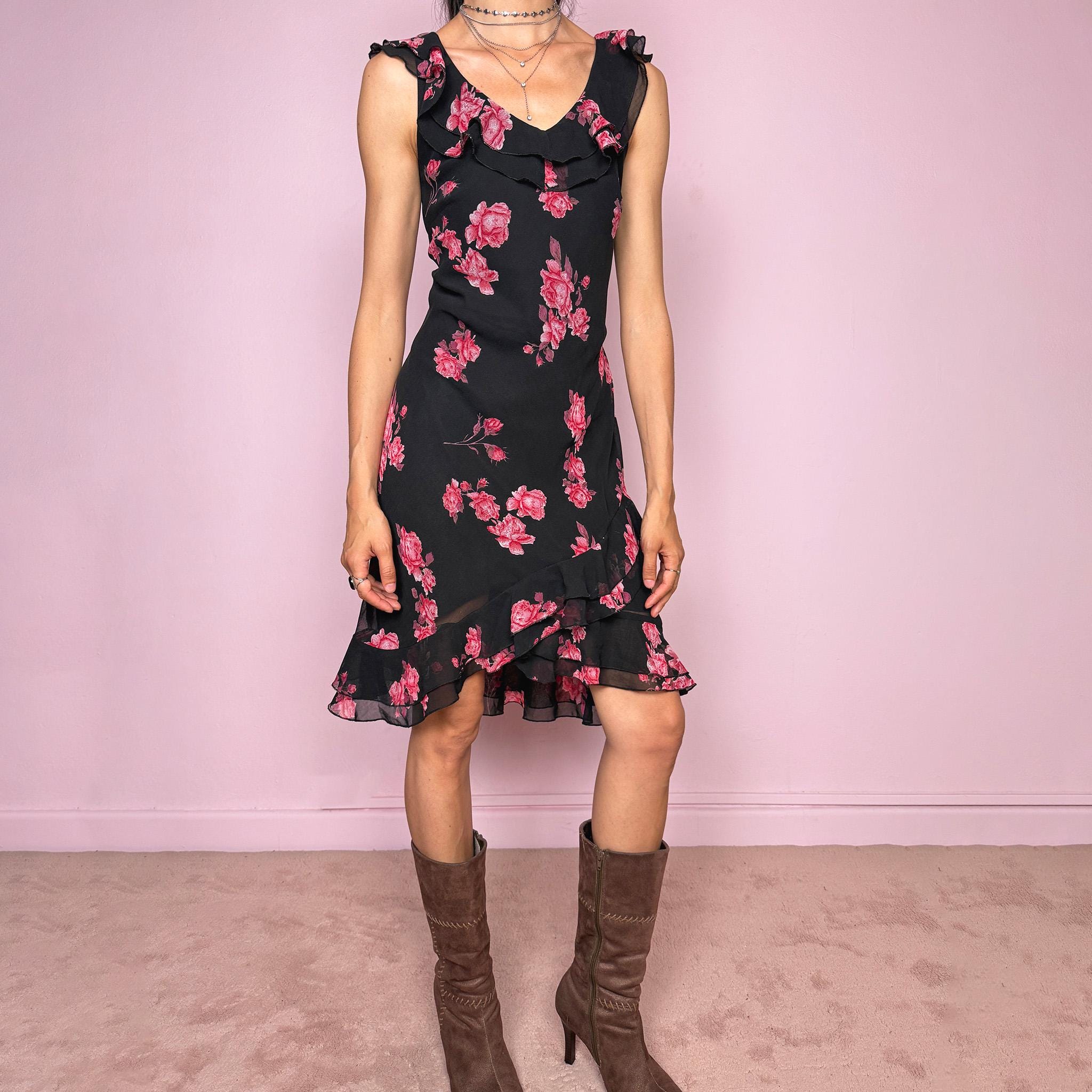 Vintage 2000s black floral mini dress with a romantic 90s feel, pink rose print, sleeveless fitted silhouette, V neckline, ruffled bust and straps, and an asymmetric layered ruffle tulip hem. Ideal for feminine spring and summer looks. Made by a French brand. Great vintage condition.