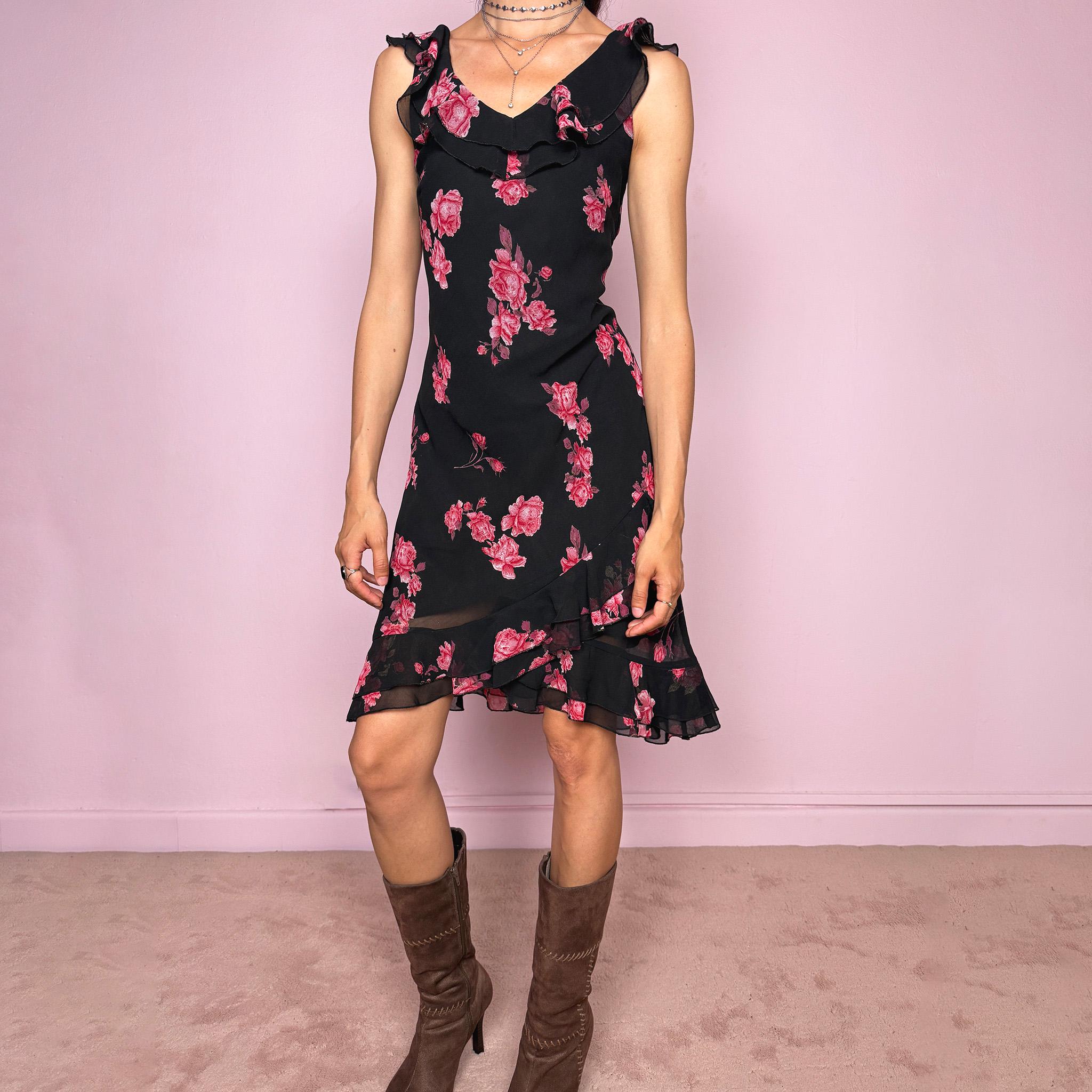Vintage 2000s black floral mini dress with a romantic 90s feel, pink rose print, sleeveless fitted silhouette, V neckline, ruffled bust and straps, and an asymmetric layered ruffle tulip hem. Ideal for feminine spring and summer looks. Made by a French brand. Great vintage condition.