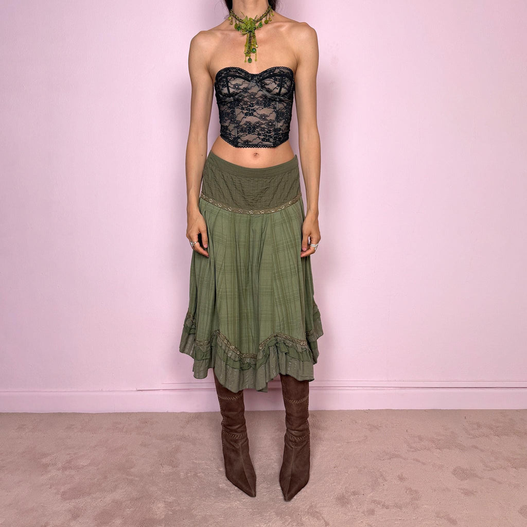 Vintage 2000s olive green khaki midi skirt with a soft bohemian feel, featuring a gathered silhouette, pleated waist panel, and layered ruffle hem with floral embroidered trim details. Designed in non-stretch 100% cotton fabric with a side zip closure, the skirt has a romantic, earthy look. Can be worn mid-rise for size L. Great vintage condition.