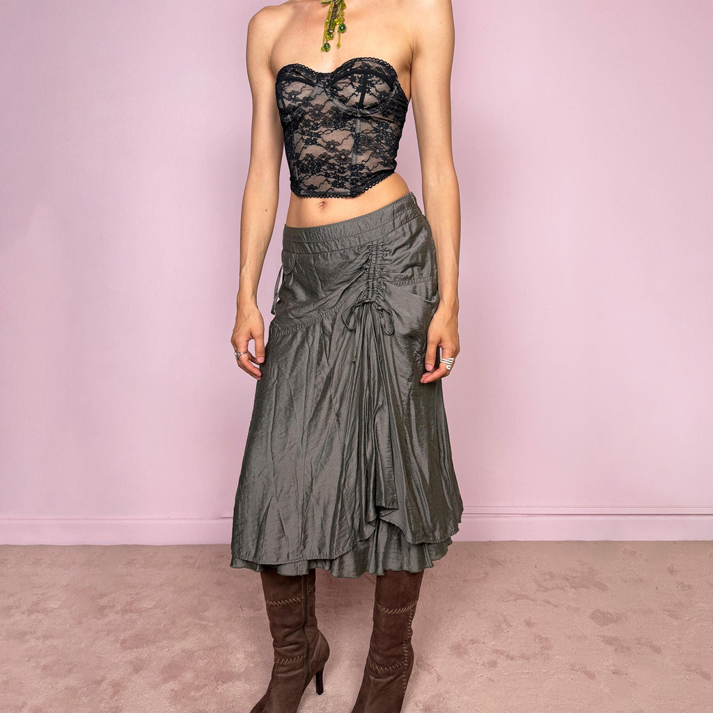Vintage 2000s greenish-gray layered midi skirt featuring a fluid draped silhouette, ruched side detail with tie accents, and a softly flared layered hem. Designed in a non-stretch 83% viscose-blend fabric with a side zip closure and full polyester lining, the skirt has an avant-garde deconstructed aesthetic. Can be worn high-waisted for size L or lower-rise for M. Great vintage condition.