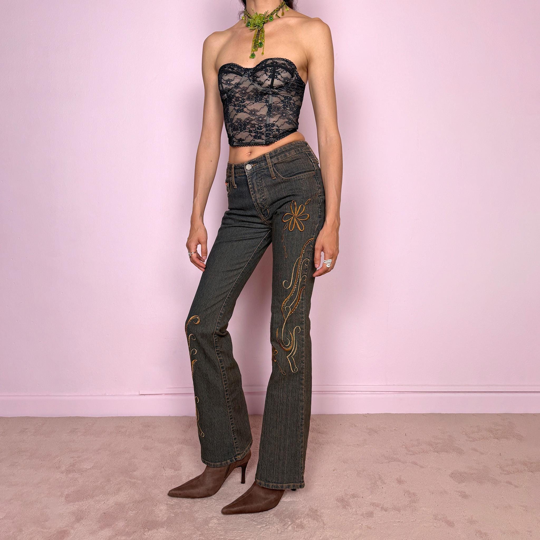 Vintage 2000s dark wash flared jeans with a mid-rise fit and bronze floral embroidery along the legs. Designed in slightly stretchy denim fabric. The embroidered floral details give the jeans a strong Y2K western and bohemian feel. Excellent vintage condition.