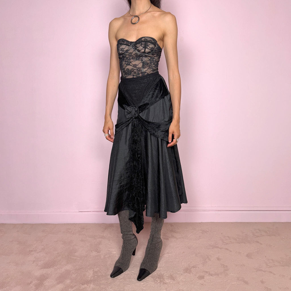 Vintage 2000s rare statement black avant-garde midi skirt made in France from 100% viscose. High-waisted fit with back zip closure, elasticated waist, dramatic flared silhouette, asymmetric draped construction, and velvet-textured front details. Dark, elegant, and sculptural, ideal for a formal party with a witchy twist. Can be worn high waisted for size S and XS. Excellent vintage condition.