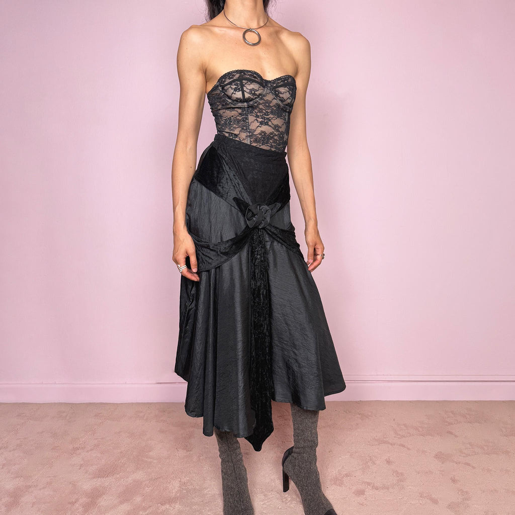 Vintage 2000s rare statement black avant-garde midi skirt made in France from 100% viscose. High-waisted fit with back zip closure, elasticated waist, dramatic flared silhouette, asymmetric draped construction, and velvet-textured front details. Dark, elegant, and sculptural, ideal for a formal party with a witchy twist. Can be worn high waisted for size S and XS. Excellent vintage condition.