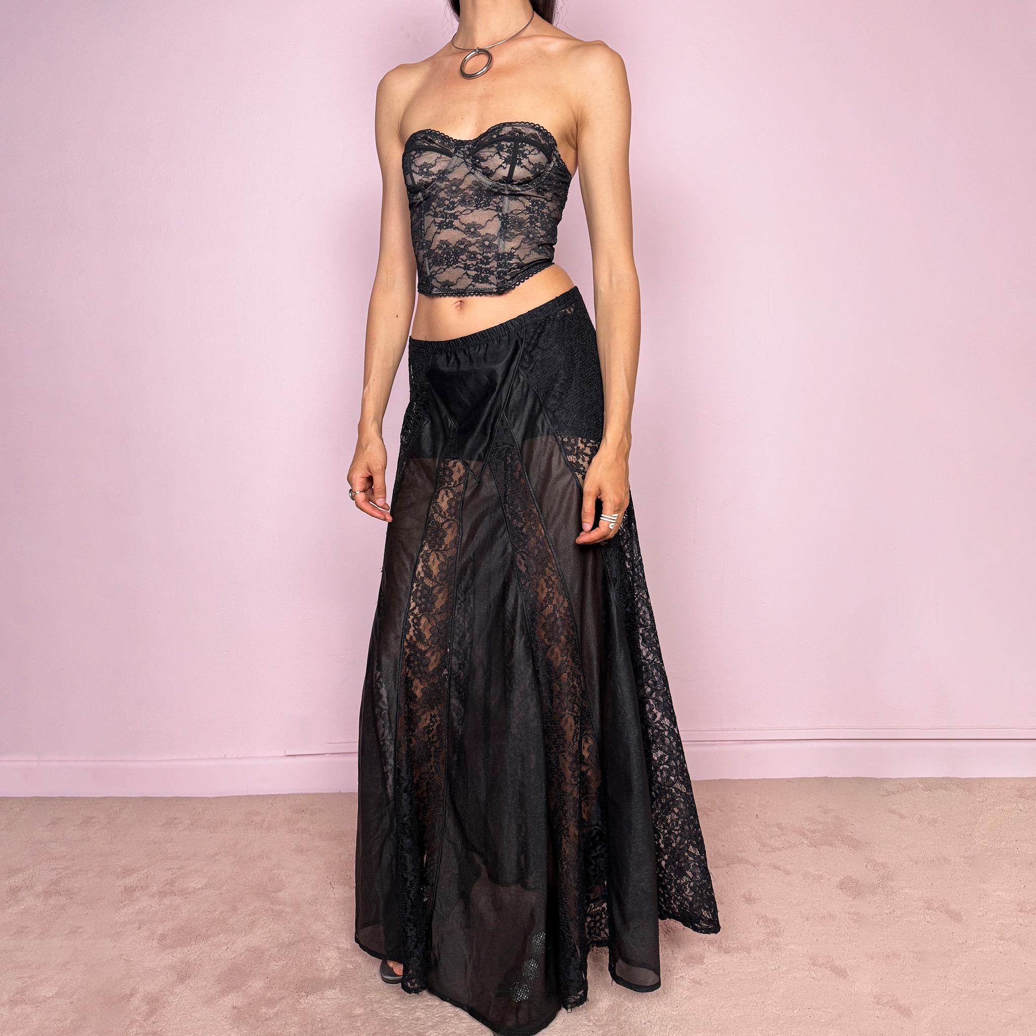 Vintage 90s black gothic maxi skirt with an elasticated waist and dramatic floor-length silhouette. Features sheer lace panels, semi-transparent mesh sections, and layered fabric construction for a dark romantic lingerie-inspired finish. Can be worn high waisted for M or lower rise for S. Made from 100% polyester. Great vintage condition.