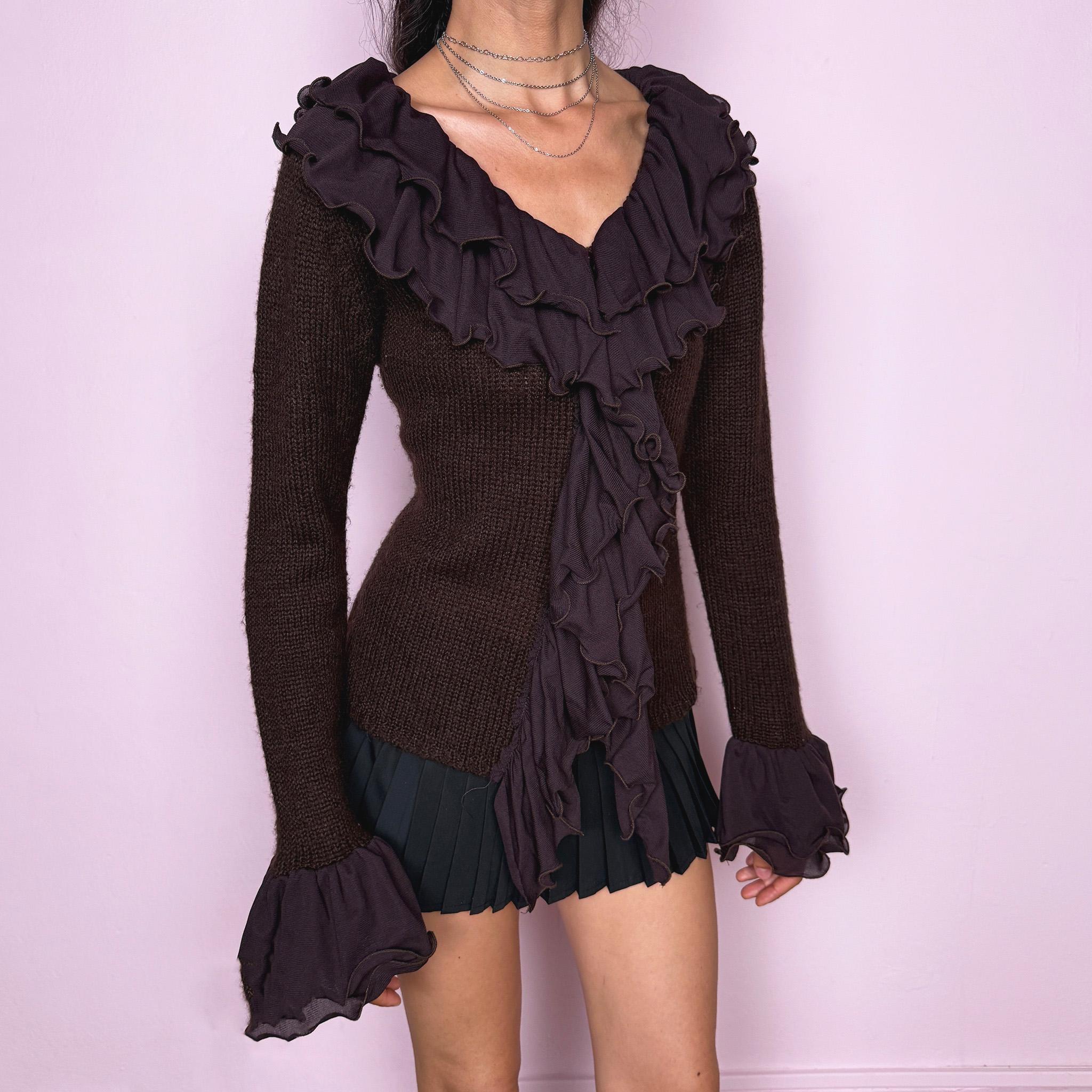 Vintage 2000s dark brown cardigan made from a stretchy knit, featuring dramatic layered mesh ruffles, delicate front buttons, and flared ruffle cuffs. A feminine dark fairy Y2K piece with a romantic statement silhouette. Made from 35% wool, 10% cashmere, and 55% acrylic. Great vintage condition.