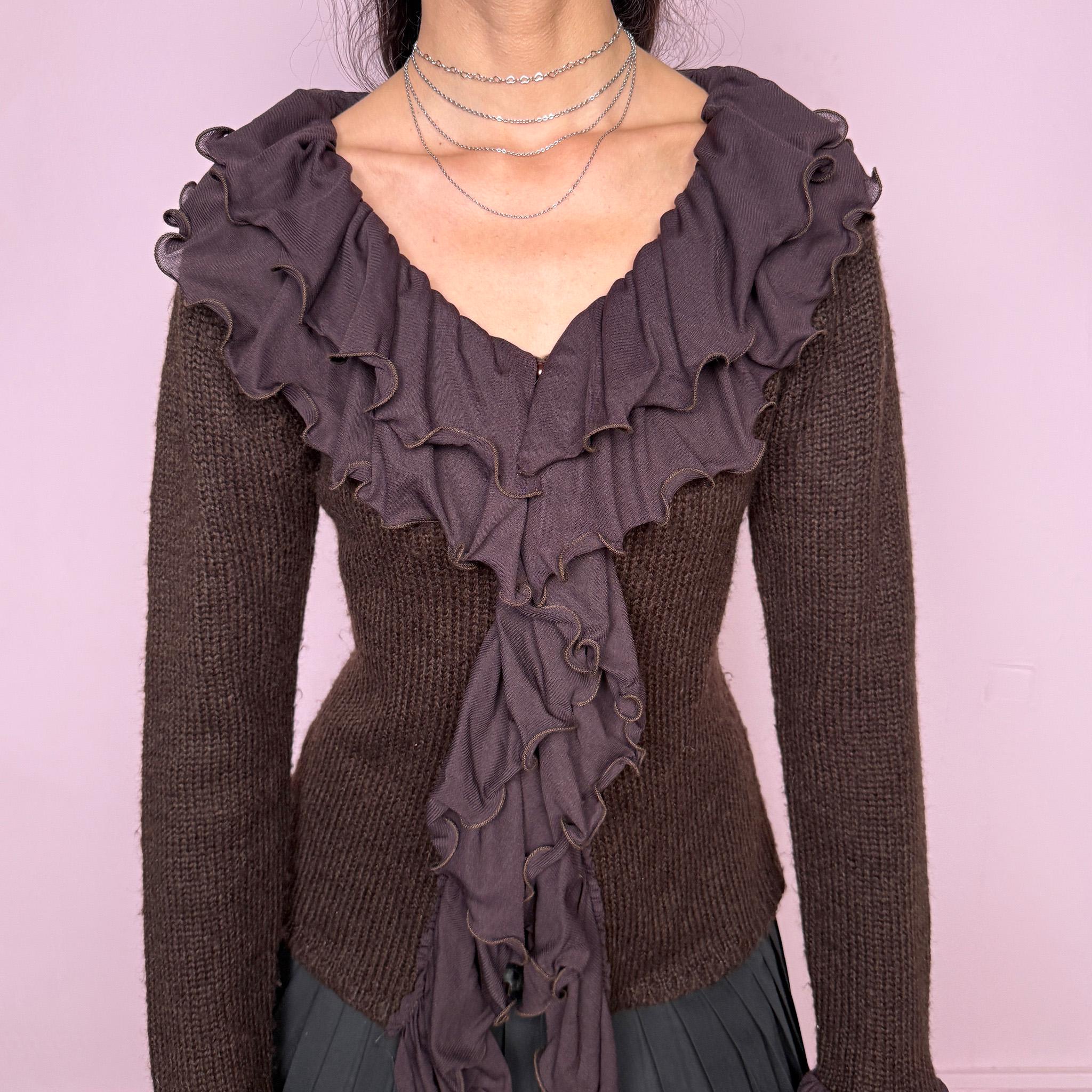 Vintage 2000s dark brown cardigan made from a stretchy knit, featuring dramatic layered mesh ruffles, delicate front buttons, and flared ruffle cuffs. A feminine dark fairy Y2K piece with a romantic statement silhouette. Made from 35% wool, 10% cashmere, and 55% acrylic. Great vintage condition.