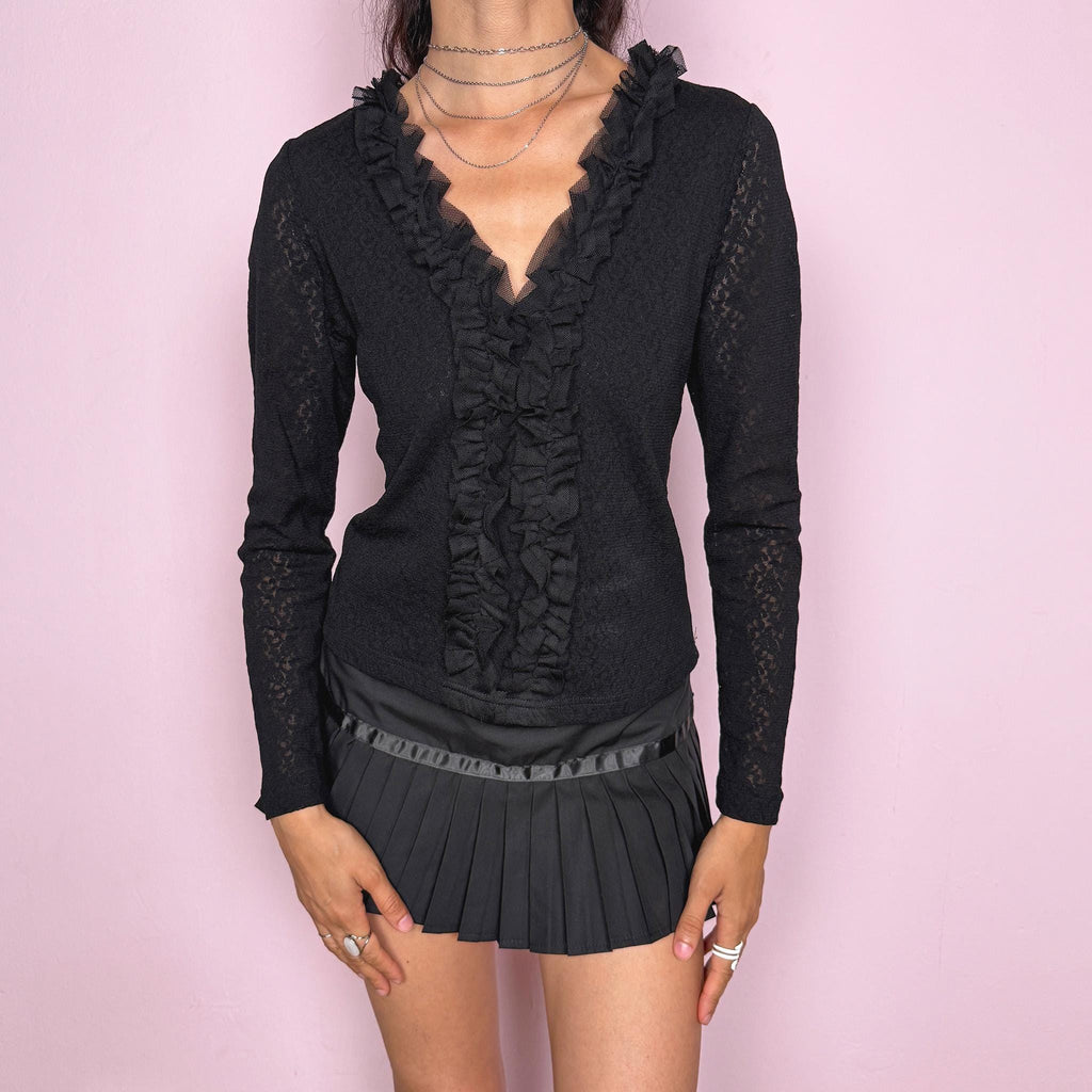 Vintage 2000s black stretch lace mesh top, designed with a fitted silhouette, sheer floral lace texture, long sleeves, and dramatic ruffle detailing through the deep V neckline. The layered mesh ruffles add a dark romantic, gothic, and feminine feel ideal for evening outfits. Made from 100% polyamide. Excellent vintage condition.