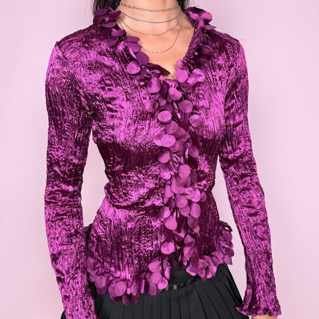 Romantic vintage 2000s purple crinkle pleated top with long flared sleeves. Features a button front and dramatic 3D floral petal trim appliqué cascading along the neckline and opening for an avant garde look. Perfect for formal, party, night, or evening wear. From a French brand. Made from 100% polyester. Excellent vintage condition.