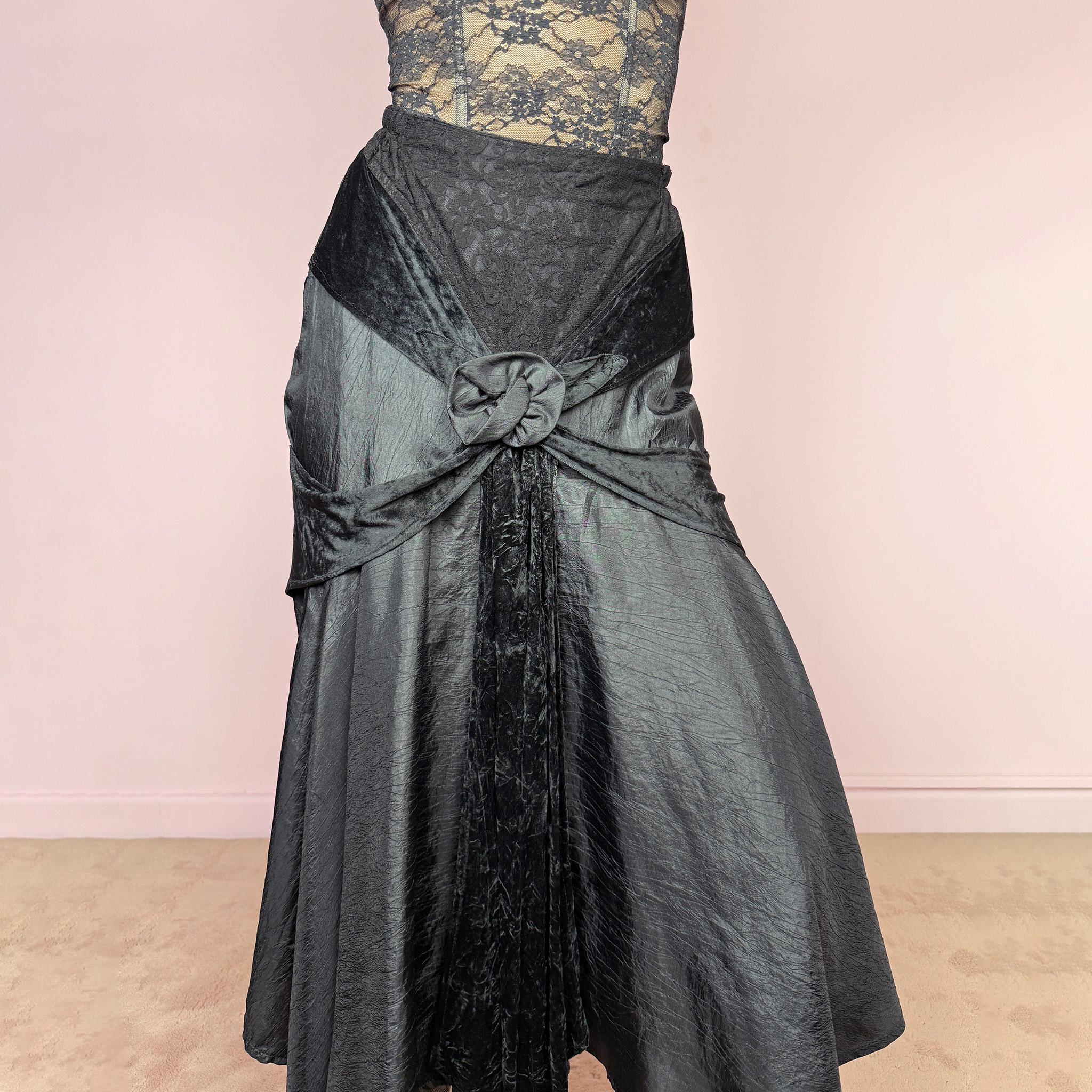 Vintage 2000s rare statement black avant-garde midi skirt made in France from 100% viscose. High-waisted fit with back zip closure, elasticated waist, dramatic flared silhouette, asymmetric draped construction, and velvet-textured front details. Dark, elegant, and sculptural, ideal for a formal party with a witchy twist. Can be worn high waisted for size S and XS. Excellent vintage condition.