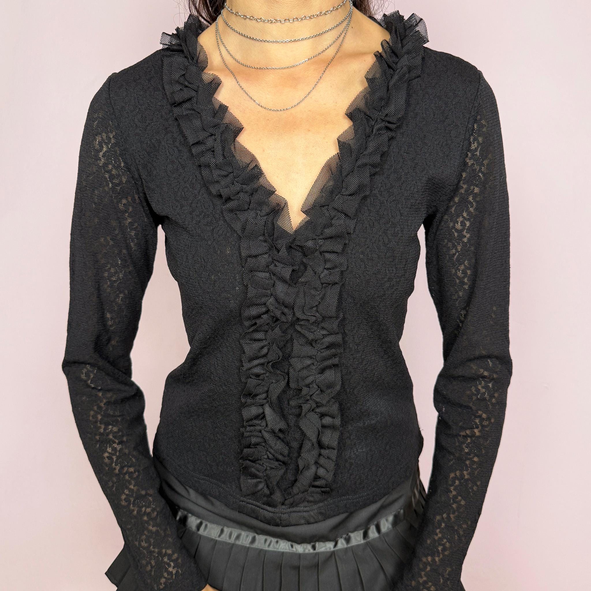 Vintage 2000s black stretch lace mesh top, designed with a fitted silhouette, sheer floral lace texture, long sleeves, and dramatic ruffle detailing through the deep V neckline. The layered mesh ruffles add a dark romantic, gothic, and feminine feel ideal for evening outfits. Made from 100% polyamide. Excellent vintage condition.