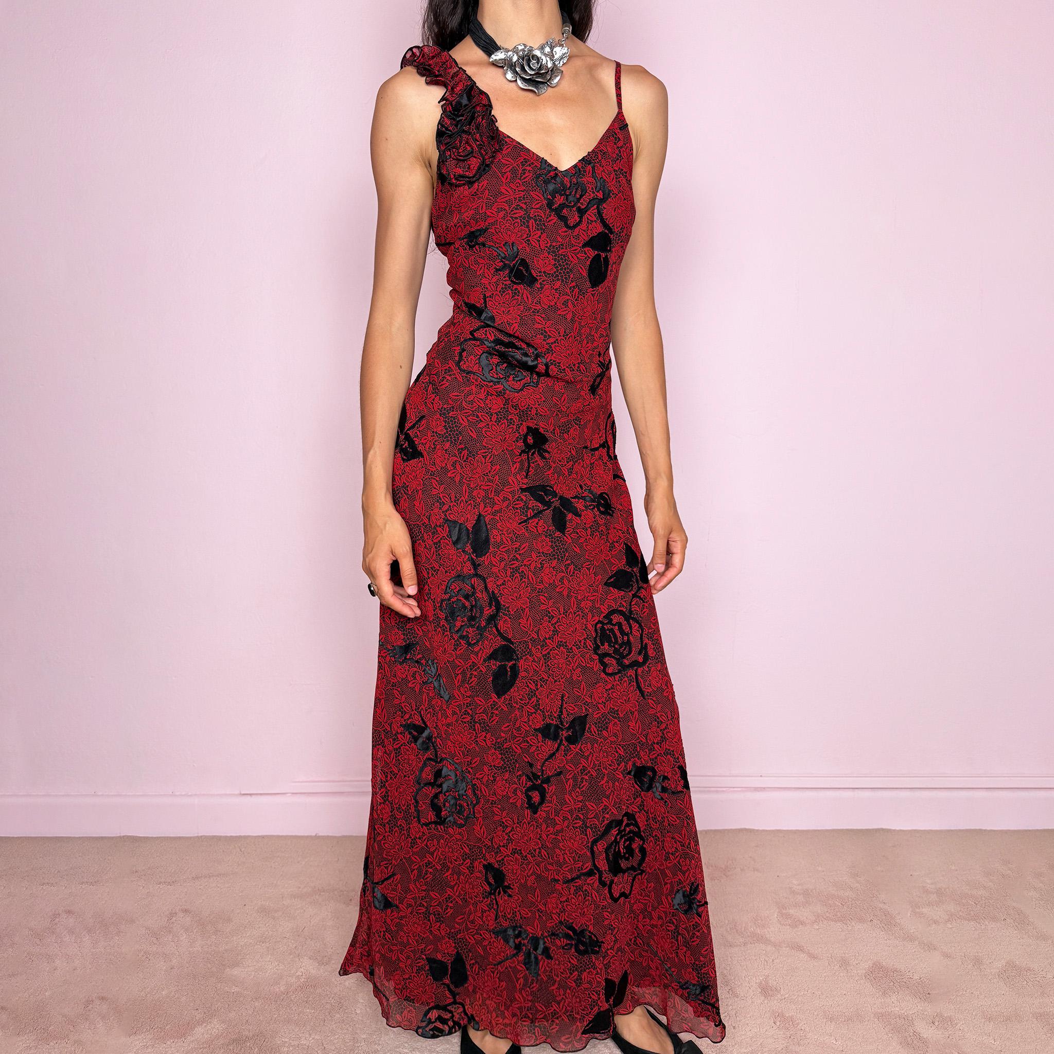Vintage 2000s red and black floral maxi dress with a fitted silhouette, spaghetti straps, and a dramatic ruffle detail at one shoulder. Designed with a V neckline, long flowing skirt, and black floral motifs over a deep red base, creating a dark romantic evening look. Lightweight with no stretch, a softly semi-sheer outer layer, and black lining, perfect for formal occasions. Composition label is missing, so the exact fabric is unknown. Excellent vintage condition.