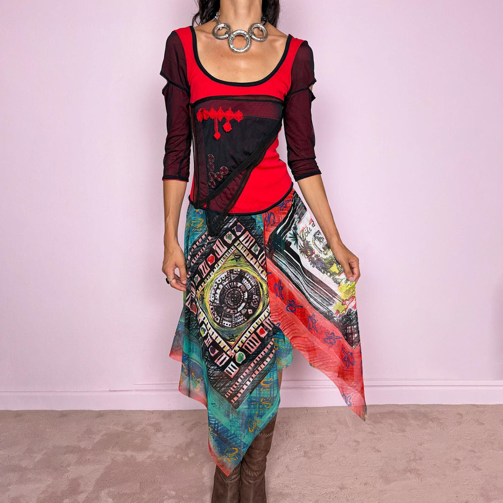 Vintage 2000s Save The Queen dress crafted from a stretchy semi-sheer mesh fabric with a bold graphic design. Designed in a fitted statement silhouette, it features a vivid red and black upper body with half sleeves and layered asymmetric panels that fall into a striking mixed-print skirt with abstract, geometric and hand-drawn motifs in red, turquoise, yellow, black and white tones. A highly visual Italian Y2K piece with an art-to-wear feel, perfect for a dramatic maximalist 2000s look.
