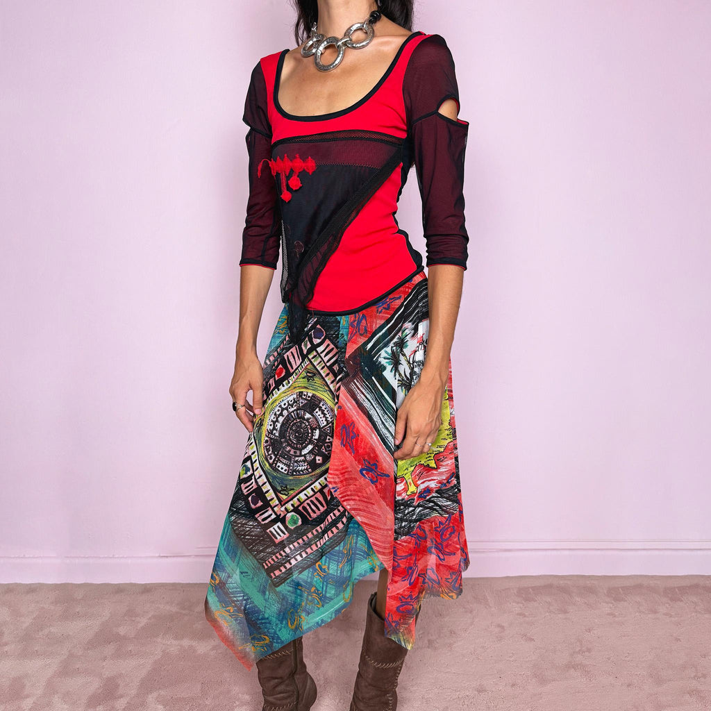 Vintage 2000s Save The Queen dress crafted from a stretchy semi-sheer mesh fabric with a bold graphic design. Designed in a fitted statement silhouette, it features a vivid red and black upper body with half sleeves and layered asymmetric panels that fall into a striking mixed-print skirt with abstract, geometric and hand-drawn motifs in red, turquoise, yellow, black and white tones. A highly visual Italian Y2K piece with an art-to-wear feel, perfect for a dramatic maximalist 2000s look.