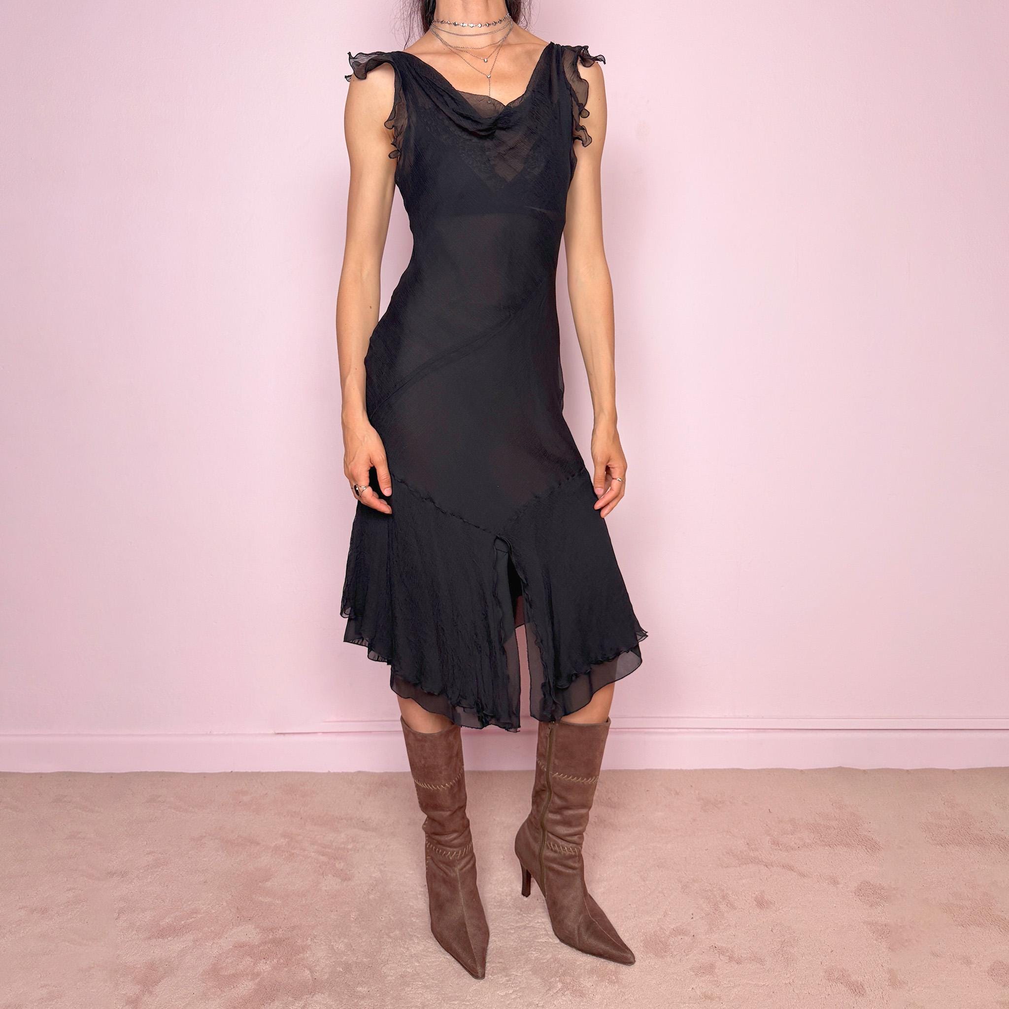 Vintage 2000s black midi dress with a romantic draped silhouette and semi-sheer layered construction. Designed with a cowl-style neckline, delicate ruffled cap sleeves, fitted waist, front slit detail, and fluid layered asymmetrical hem for an elegant dark evening look. The outer layer looks and feels like silk, but all labels are missing, so the exact fabric composition is unknown. Excellent vintage condition.