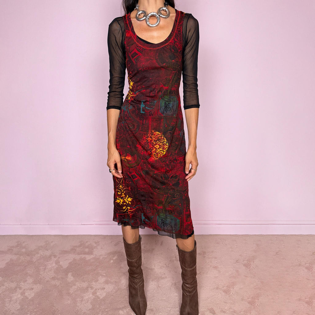 Vintage 2000s layered mesh midi dress, designed as a two-piece dress set that can be worn together or separately. The outer dress is sleeveless and stretchy, featuring a deep burgundy, red, and black graphic print with abstract ornamental motifs, while the inner layer is a sheer black mesh dress with 3/4 sleeves and a ruffled hem. A very versatile art-to-wear Y2K piece with dark maximalist layered transparency from a French brand.