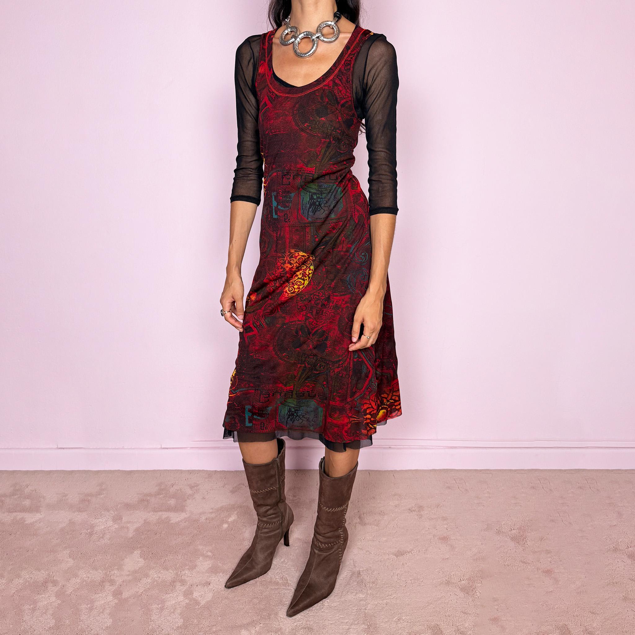 Vintage 2000s layered mesh midi dress, designed as a two-piece dress set that can be worn together or separately. The outer dress is sleeveless and stretchy, featuring a deep burgundy, red, and black graphic print with abstract ornamental motifs, while the inner layer is a sheer black mesh dress with 3/4 sleeves and a ruffled hem. A very versatile art-to-wear Y2K piece with dark maximalist layered transparency from a French brand.