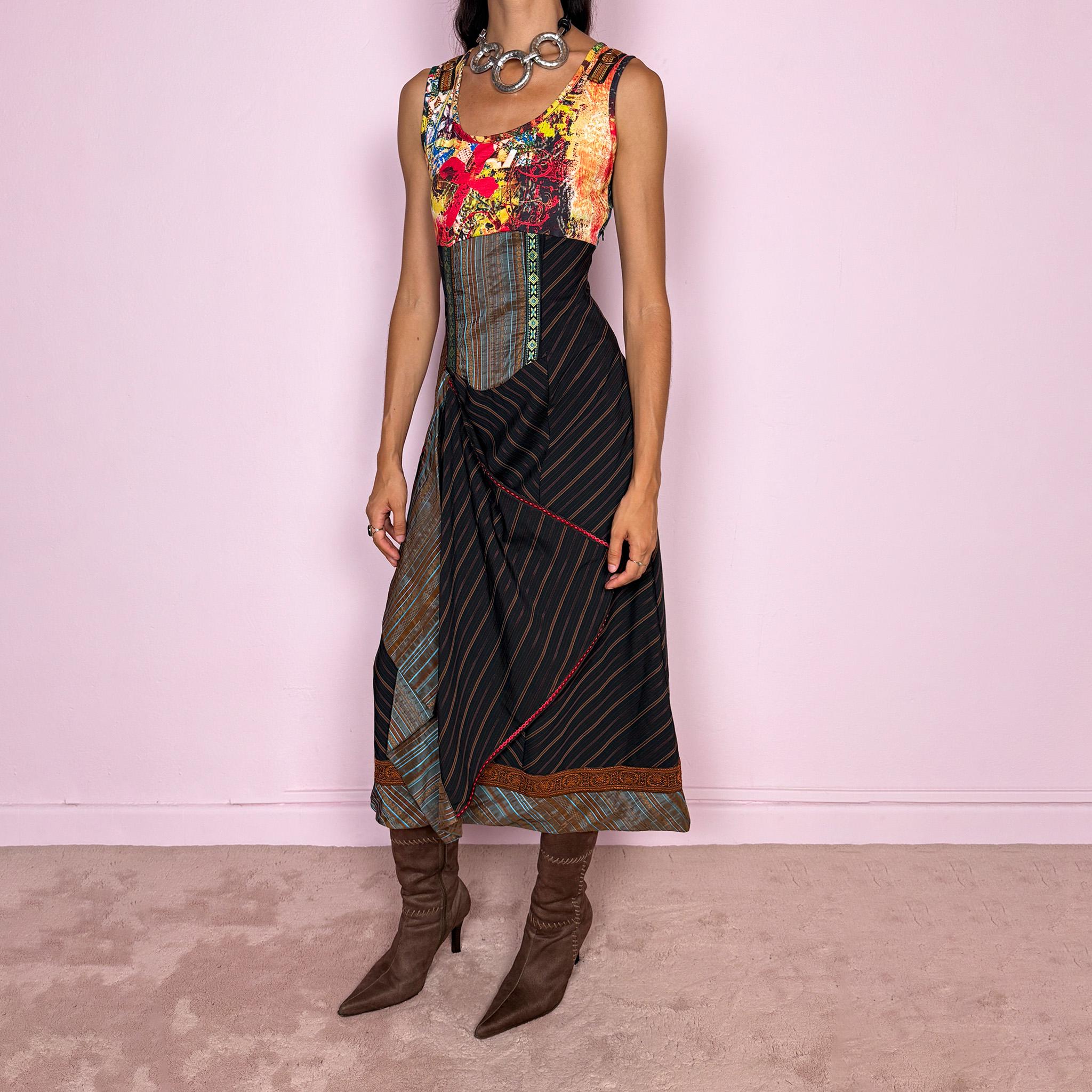 Vintage 2000s midi dress designed with a dramatic medieval-inspired avant-garde silhouette. It features a graphic bust panel with vivid abstract artwork, a fitted corset-effect waist with striped and patterned panels, a side zip closure, and a flowing asymmetric skirt with mixed striped fabrics, contrast trims, and layered draped sections for sculptural movement. Only the bust area has stretch, while the rest of the dress  A rare fantasy statement piece with a theatrical baroque feel.