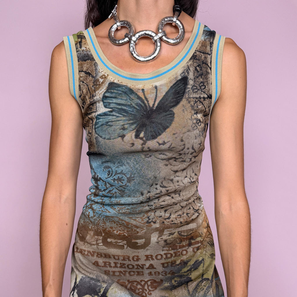Vintage 2000s fitted sleeveless midi dress in lightweight stretch mesh with matching mesh lining for a softly sheer layered effect. Features blue, green and brown butterfly graphics, faded architectural motifs, postcard-style typography and contrast trim, with a visual Y2K art-to-wear feel for maximalist editorial styling. Made in France by a French brand. Excellent vintage condition.