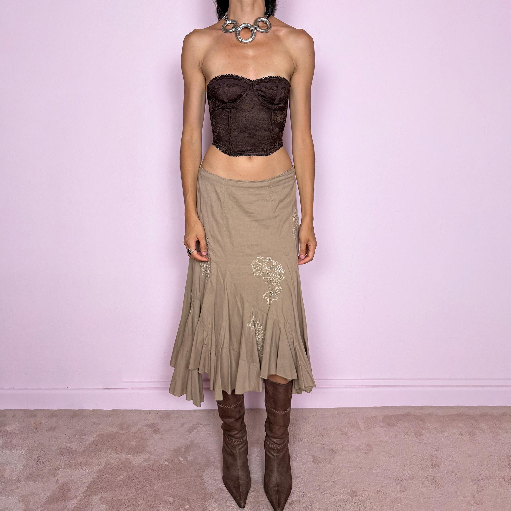 Vintage 2000s beige asymmetric midi skirt in 100% cotton with a side zip closure and no stretch. Features embroidered sequin details, soft paneling and a flared uneven ruffle hem. Romantic Y2K bohemian style, perfect for fairy summer looks. Can be worn mid rise for size M or lower rise for S. From a French brand. Excellent vintage condition.